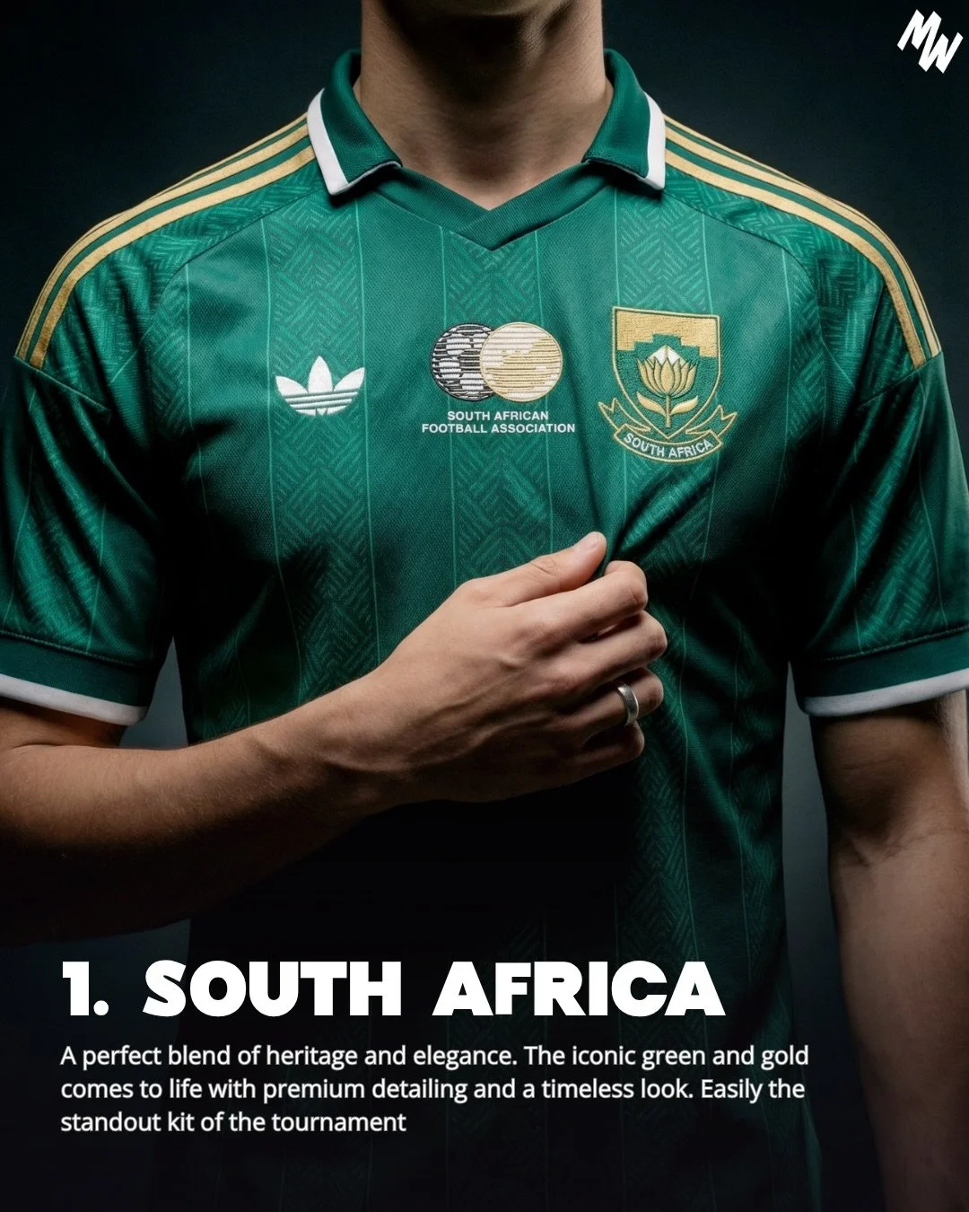 A person wearing a green South African national soccer team jersey with gold and white accents, featuring the South Africa emblem, the Adidas logo, and the South African Football Association logo. The person is holding the jersey near the chest, and 