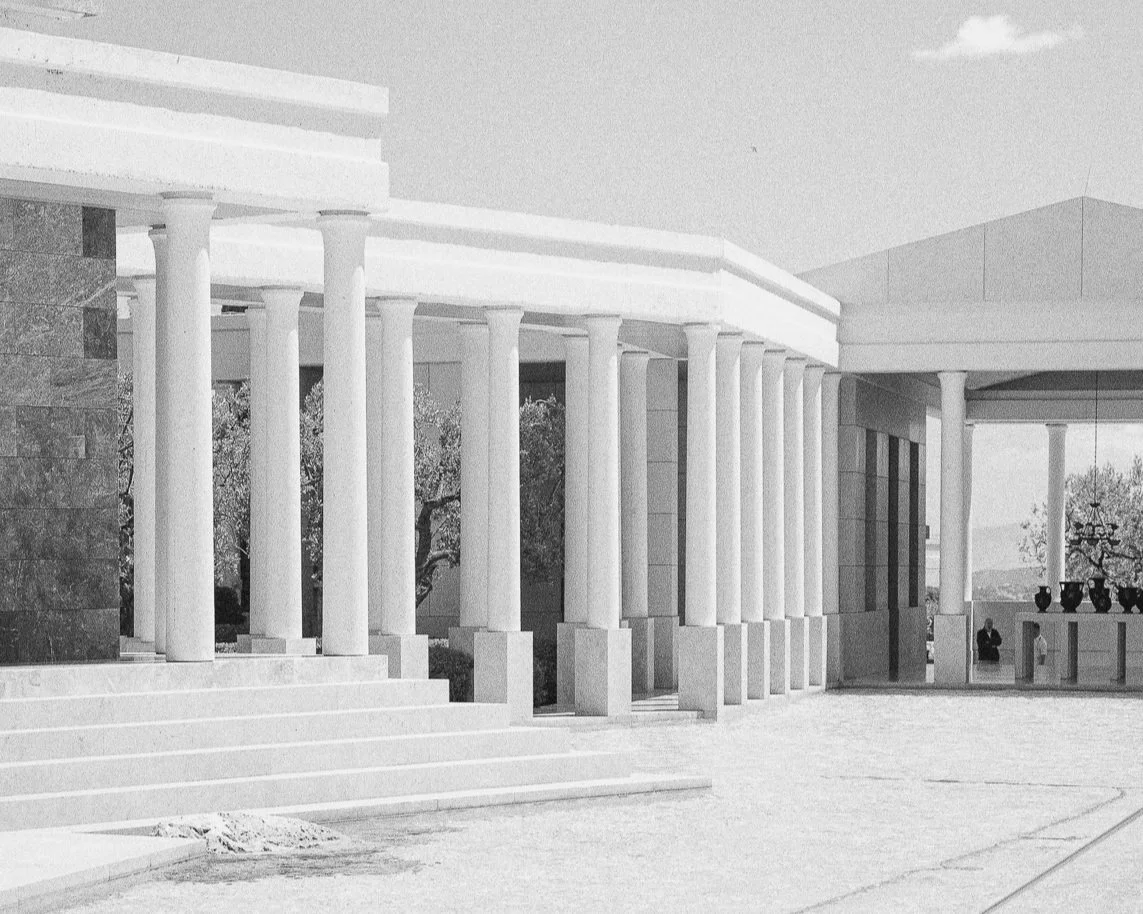 Exterior of a building with large columns and steps leading up to the entrance.