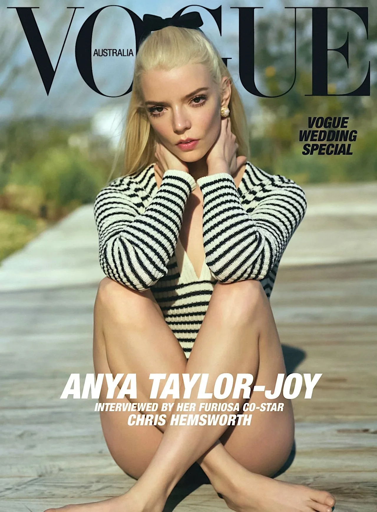 Cover of Vogue Australia featuring model Anya Taylor-Joy in a striped sweater, sitting outdoors on a homey wooden deck.