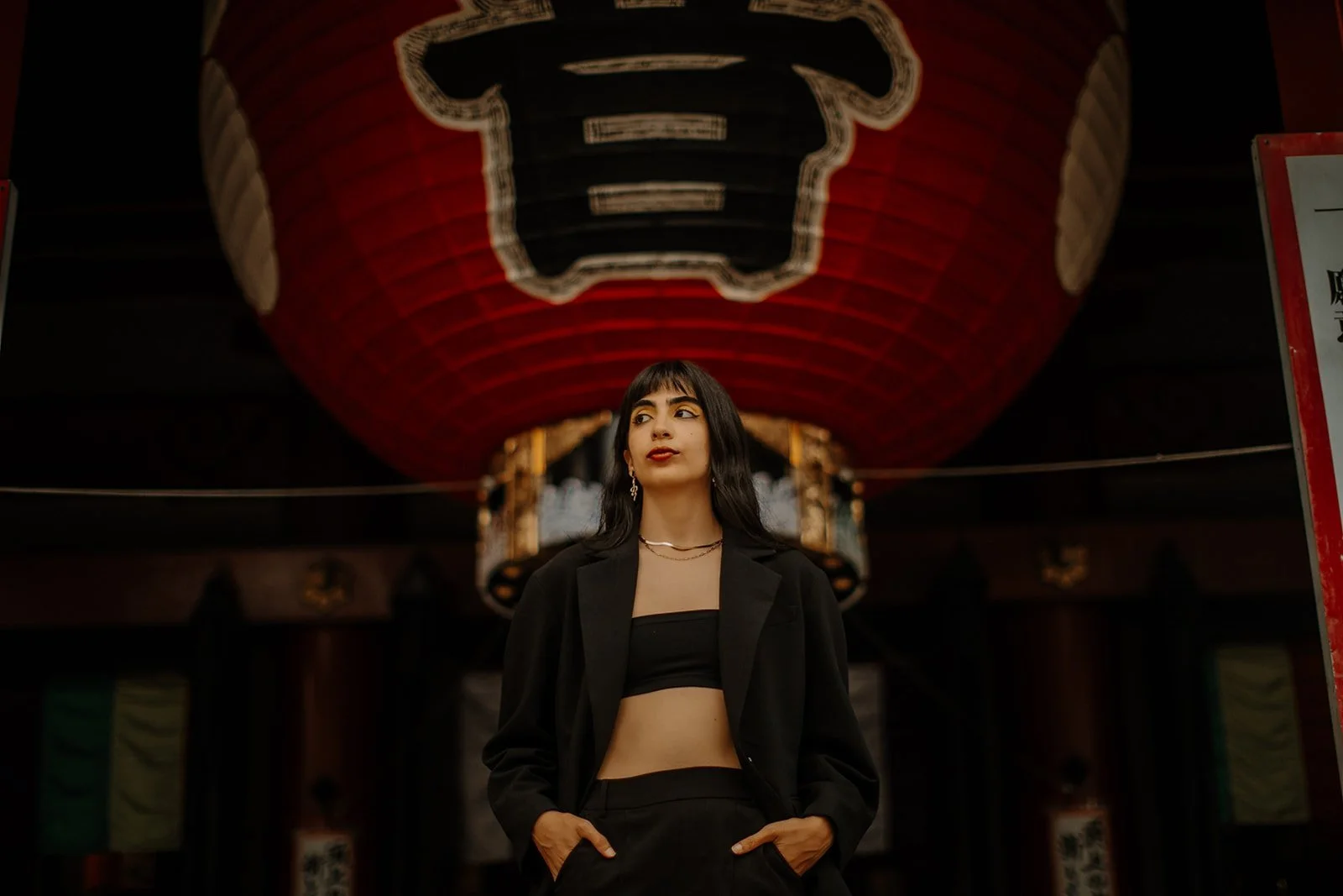 Fashion portrait beneath the giant red lantern at Kaminarimon Gate, Asakusa, Tokyo.