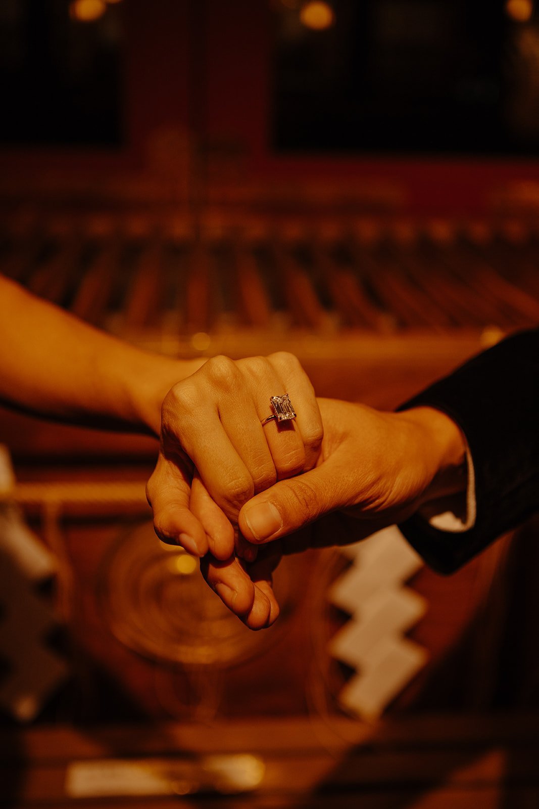 Close-up of a hand fist-bump revealing a new engagement ring at Kanda Myojin Shrine in Tokyo