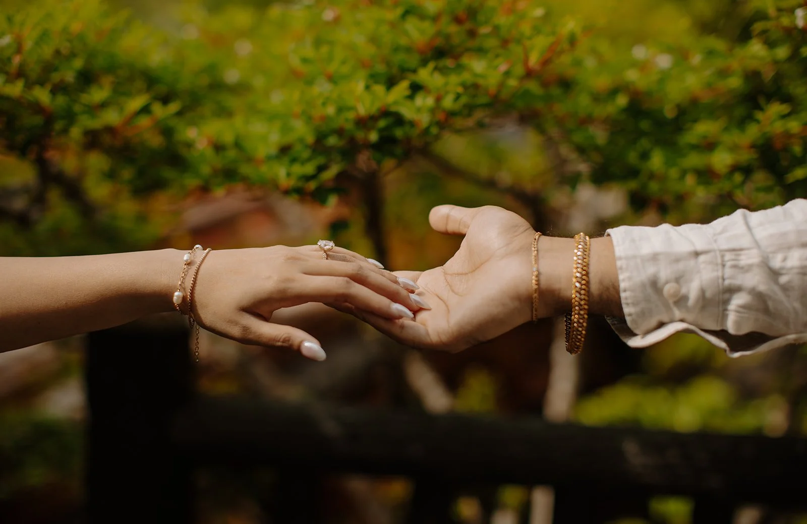 Maliha and Khizr holding each other’s hands while walking through the forest path in vacation couple photoshoot Japan