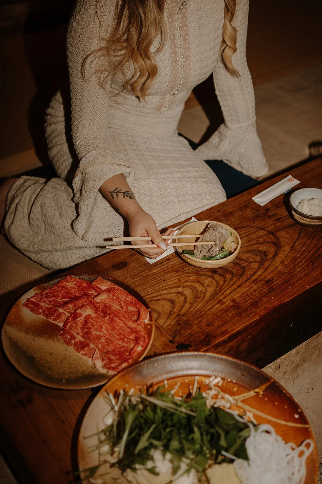 Bride enjoying a traditional shabu-shabu meal with marbled wagyu beef during an intimate elopement in Nara, Japan