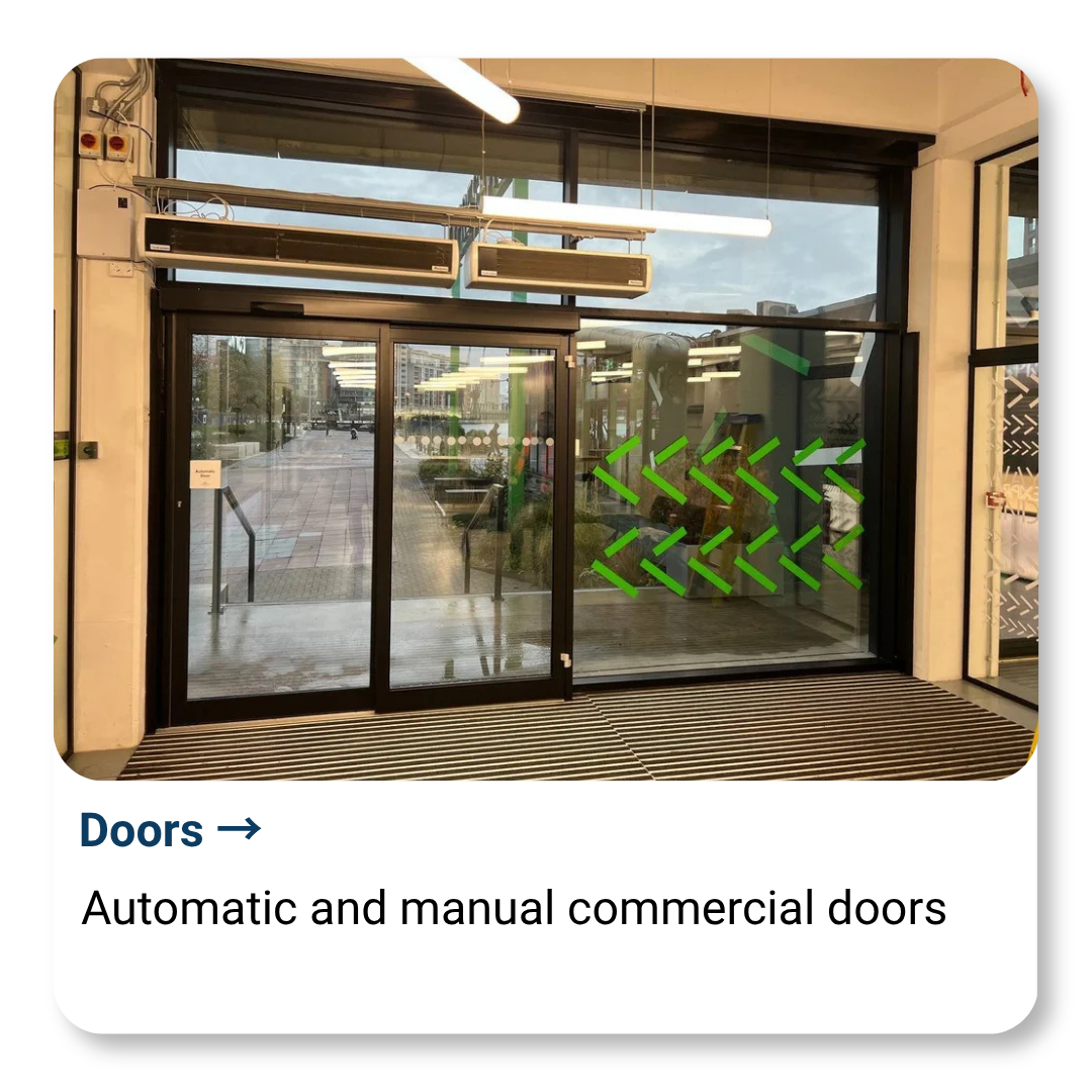 Double glass doors with green arrow markings, automatic and manual commercial doors, entrance to a building.