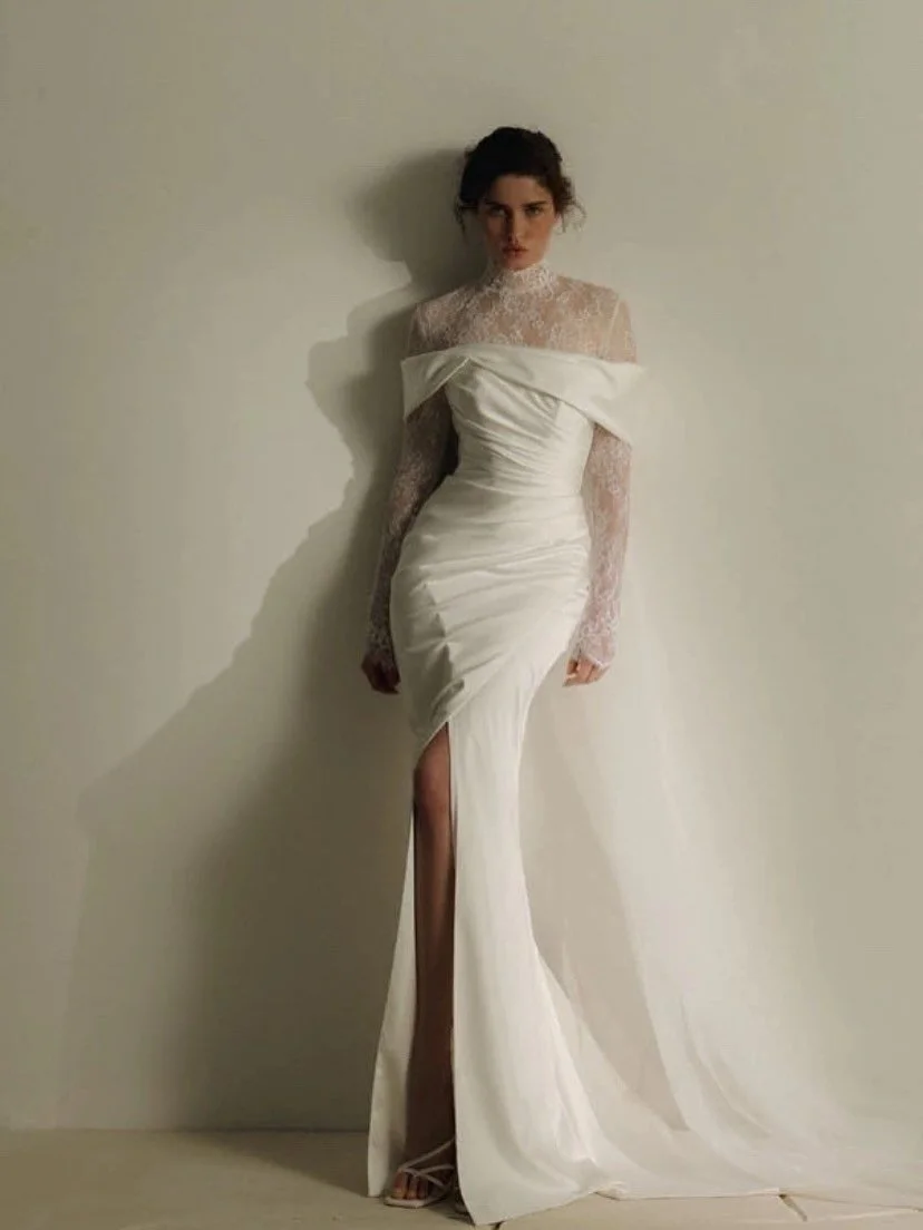 Meet Brenner, a stunning mermaid silhouette crafted from luxurious satin, paired with an intricate lace bolero. The detachable train flows elegantly from the back, creating a soft, romantic effect. Perfect for the bride seeking sophistication and fle