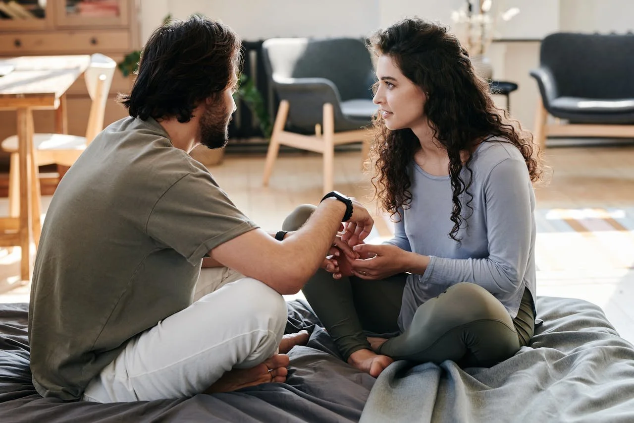 Man and woman engaged in healthy relationship communication, demonstrating connection and openness during serious conversation