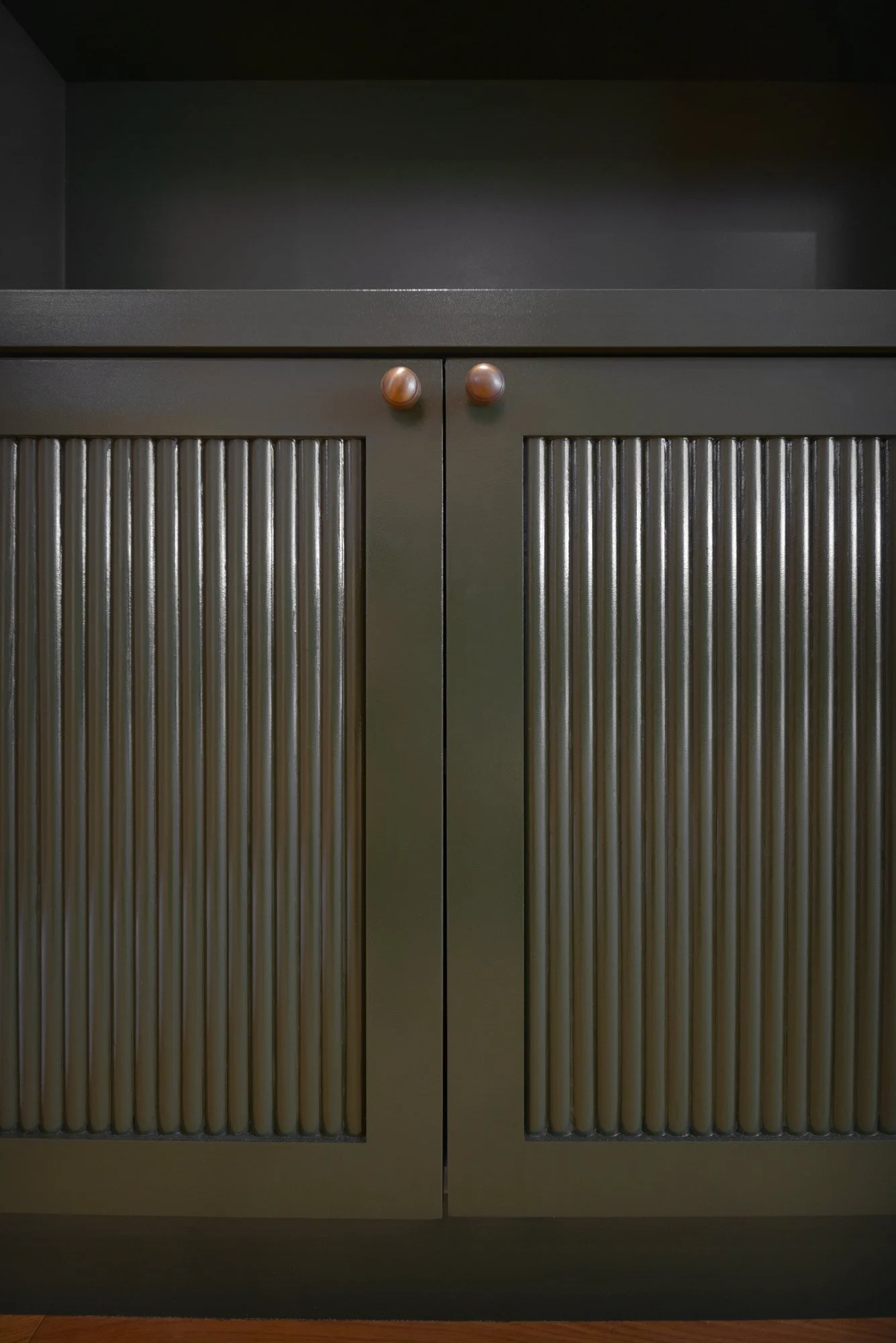 Shaker style cabinet doors with hand painted finish in dark green bespoke joinery