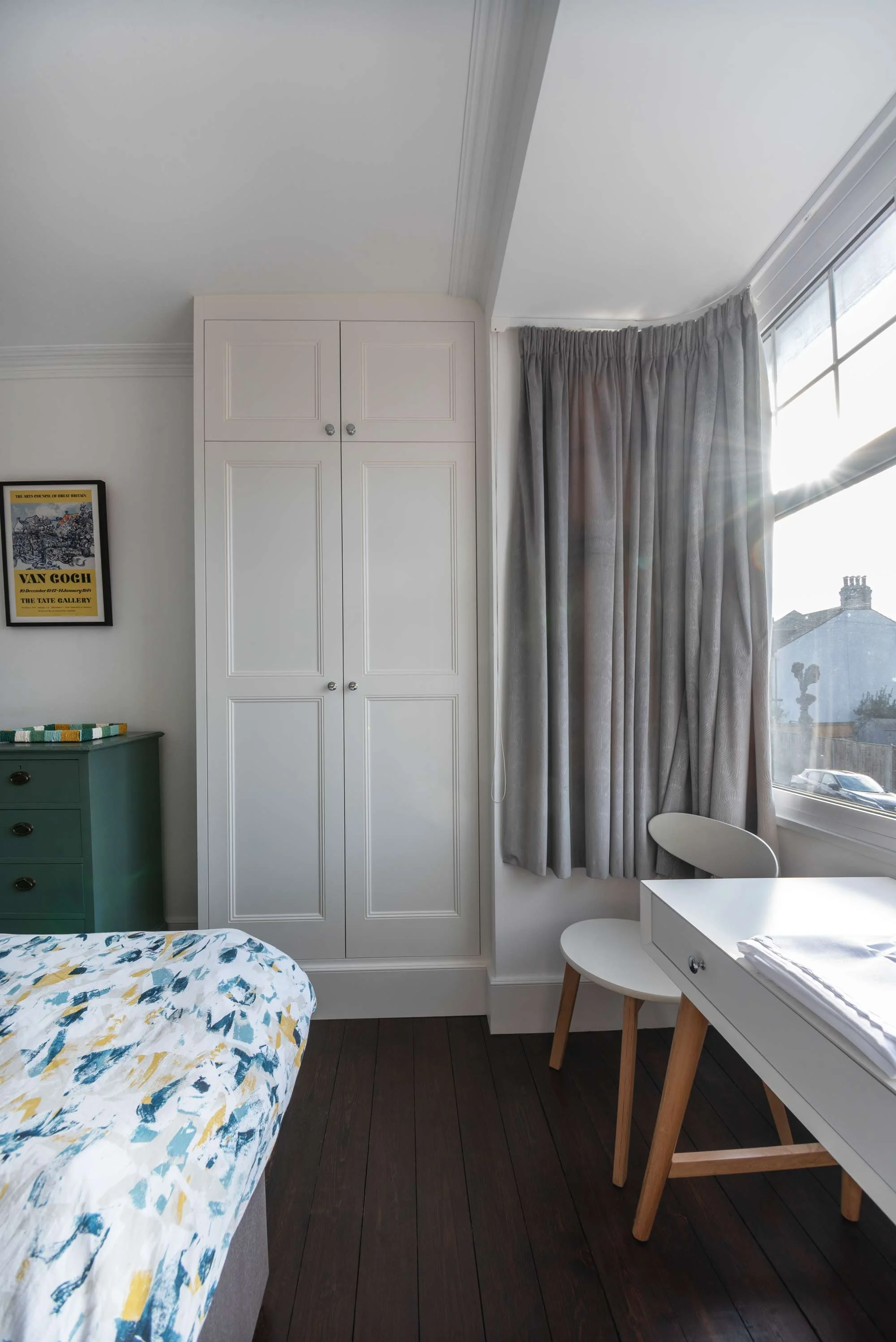 “Bespoke hand-painted shaker wardrobes in a master bedroom, fitted around chimney alcoves”