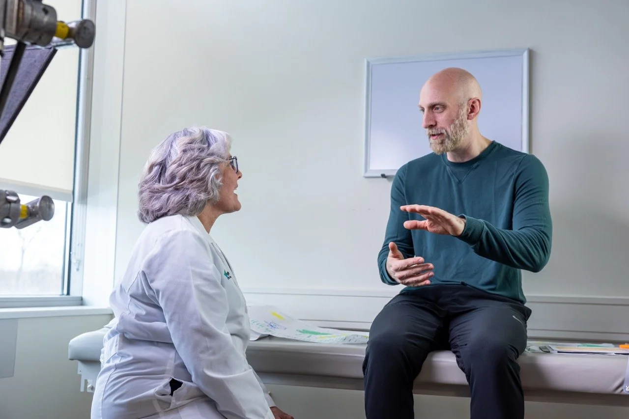 Pittsburgh commercial director talking to real doctor talent while on set for commercial TV video production in hospital room.