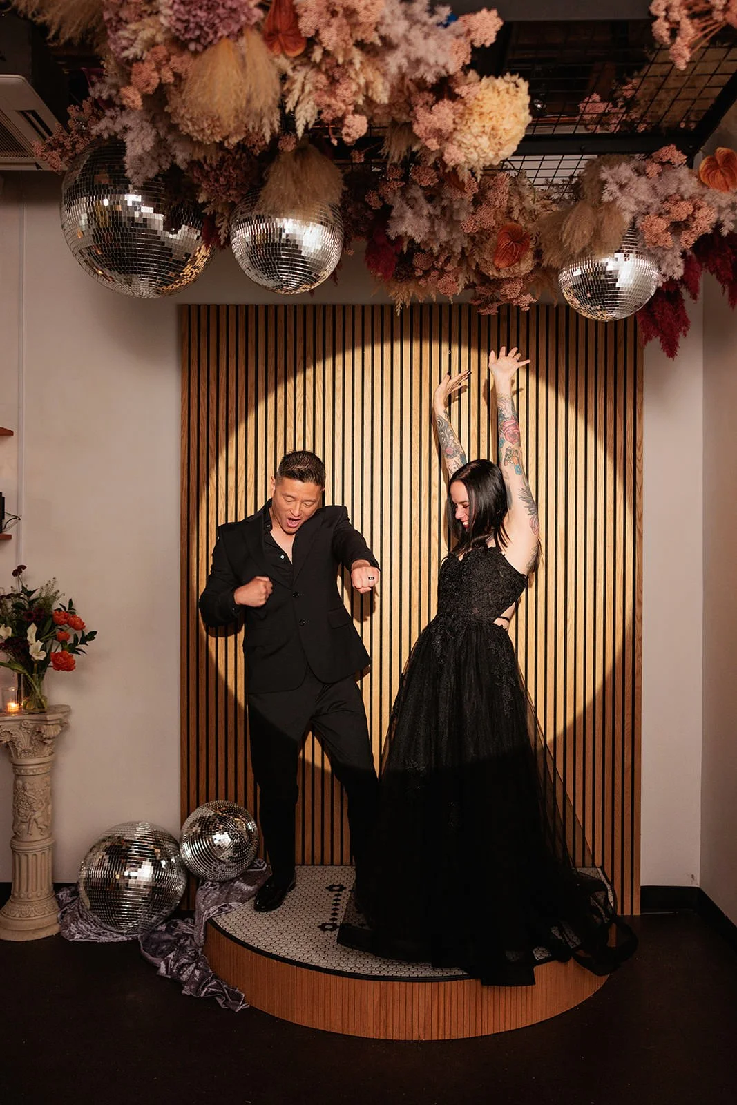  Newlyweds dancing in a spotlight on a small wedding ceremony platform.  