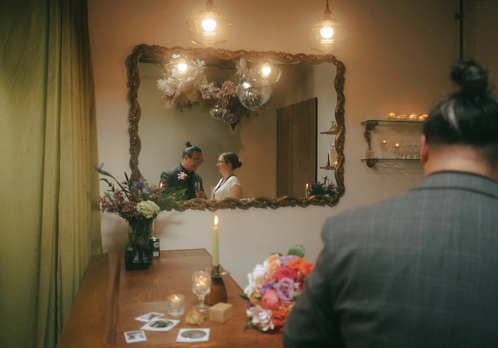  The reflection of a newlywed couple laughing in a mirror  