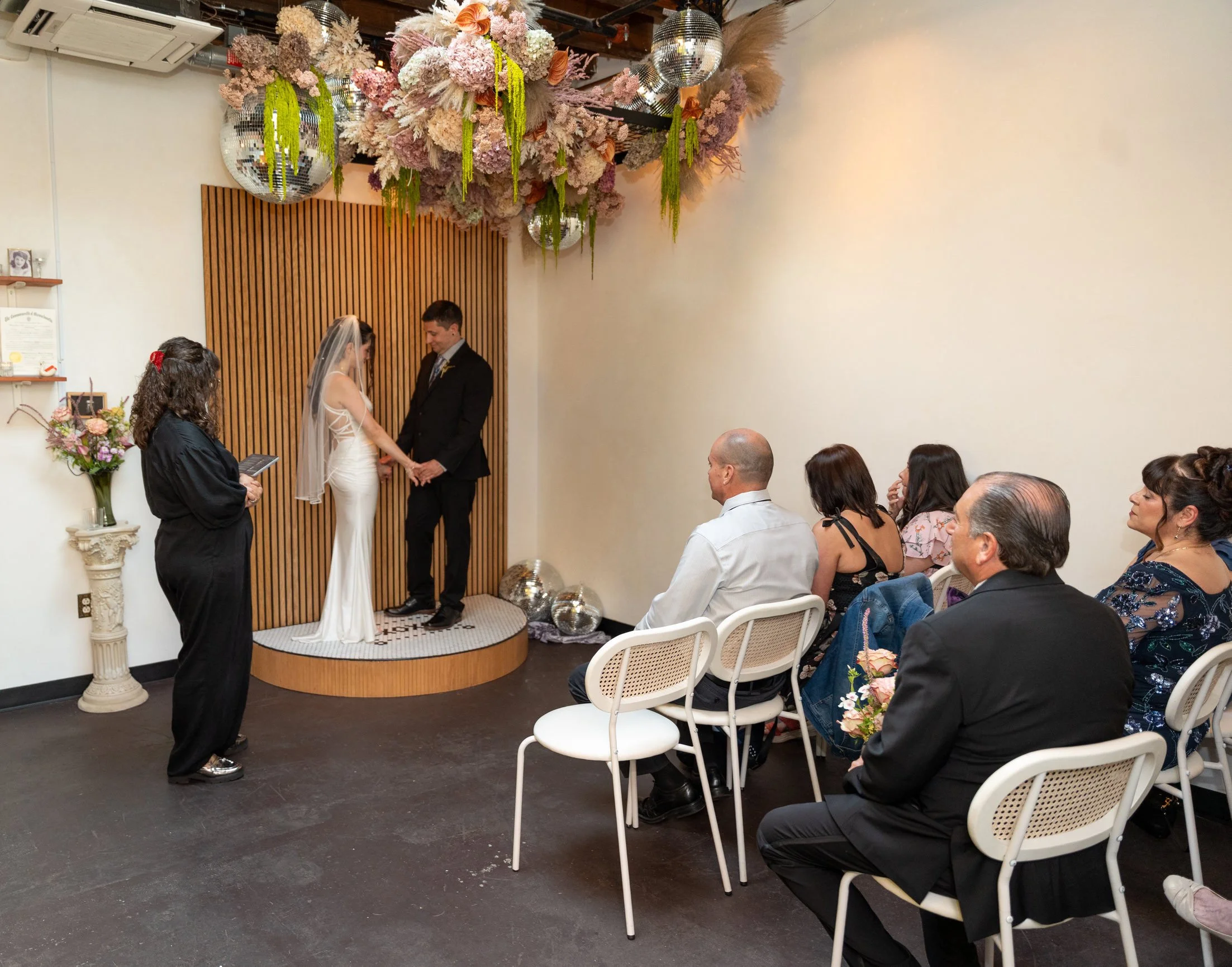 Newlyweds holding hands as they say their vows at their elopement