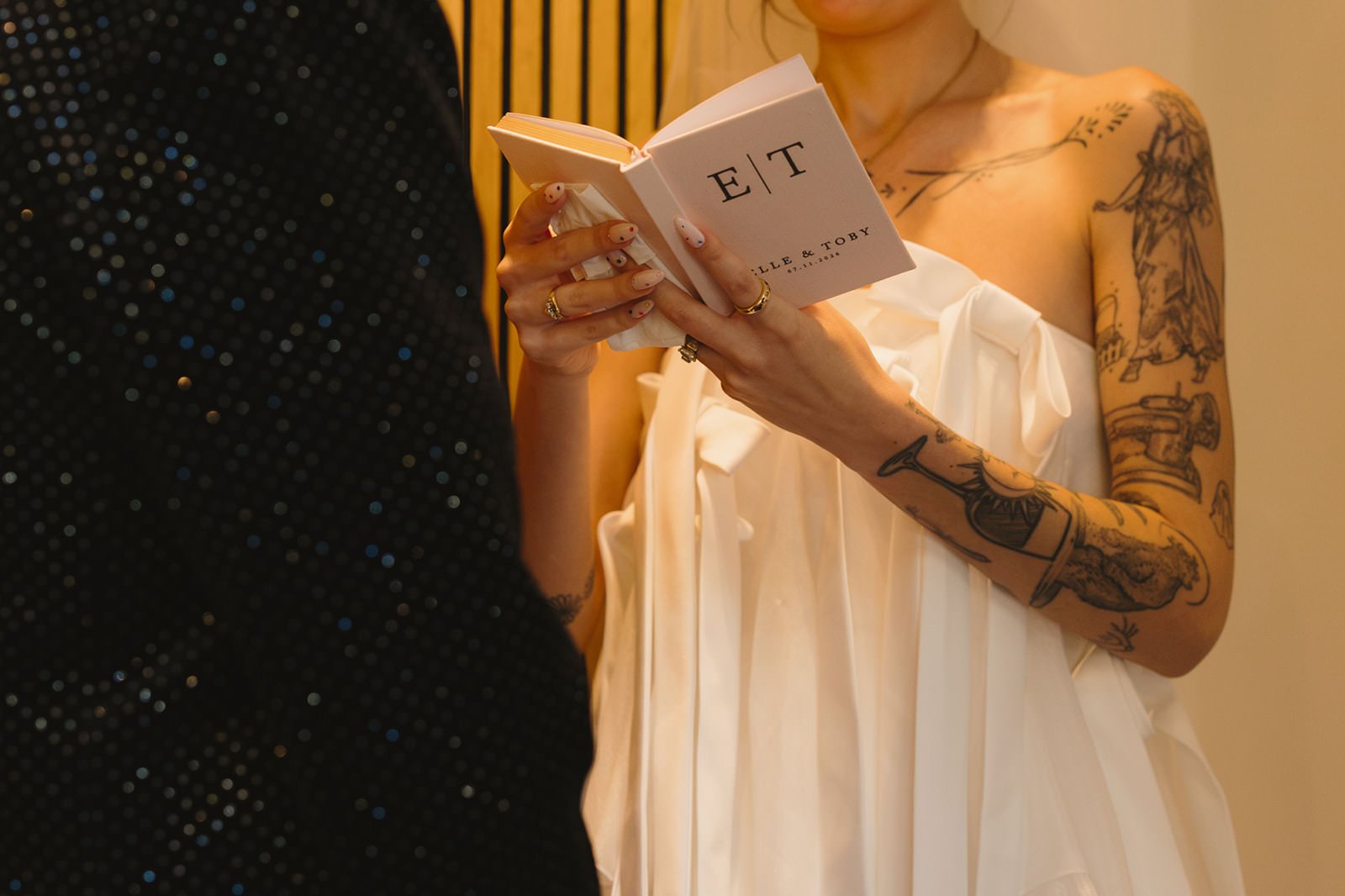 A person reading out of a vow book during their wedding ceremony