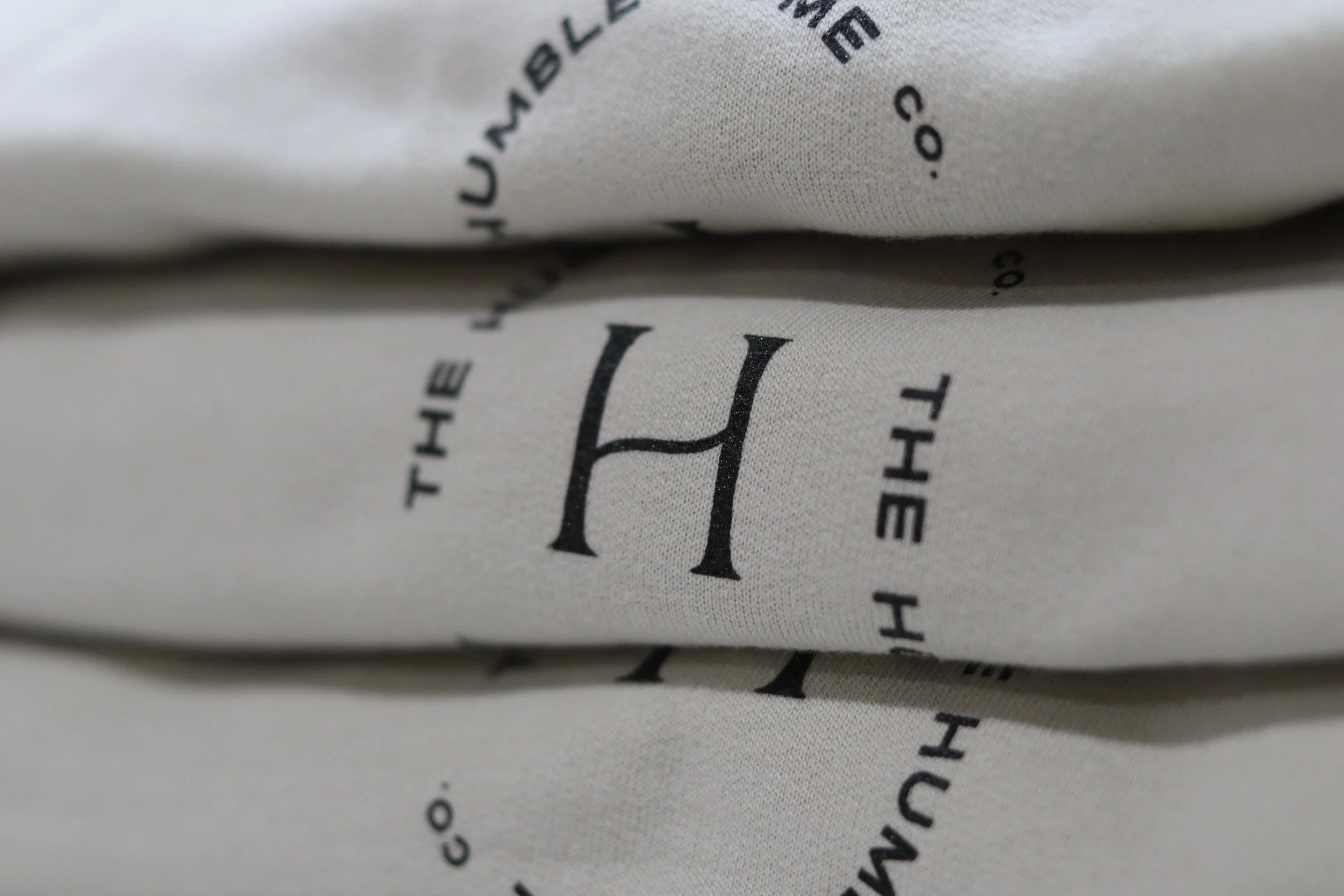 Screen printed stack of Champion Brand high quality sweaters.