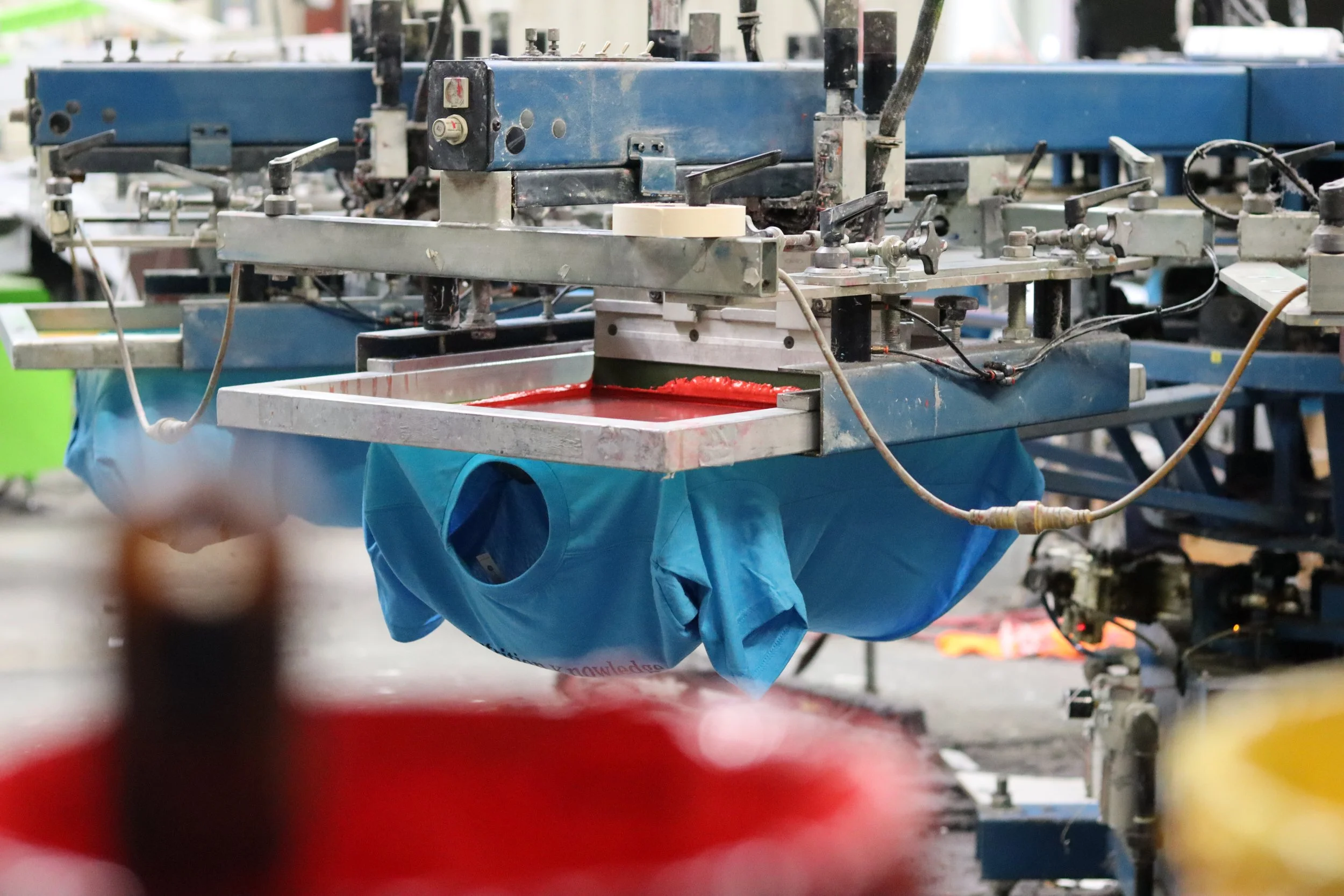 a t shirt being screen printed in the printing shop