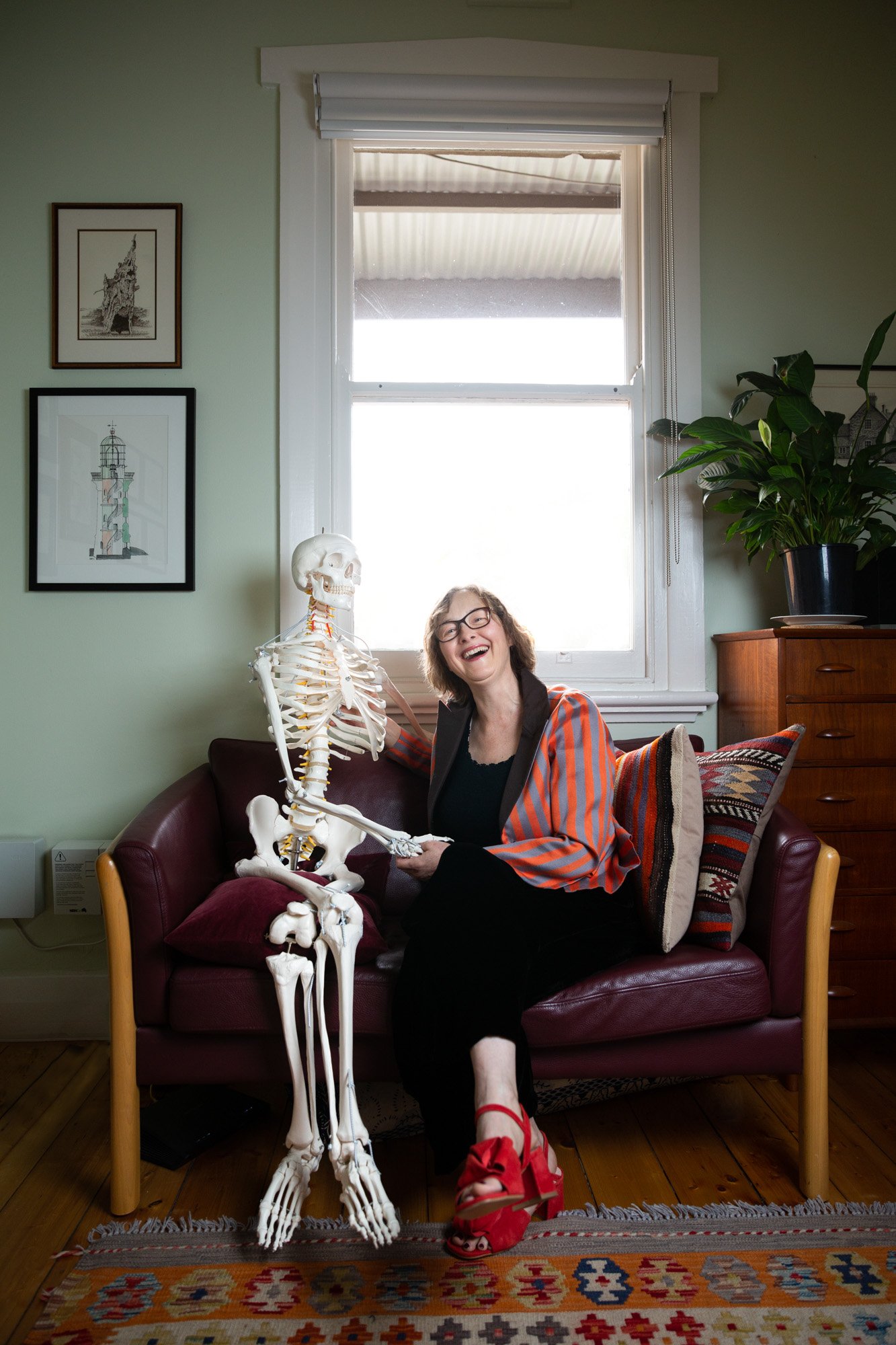 Portrait of Caroline Henbest with Feldenkrais Skeleton.  Photography by Agatha Yim, Polyphonic Pictures.