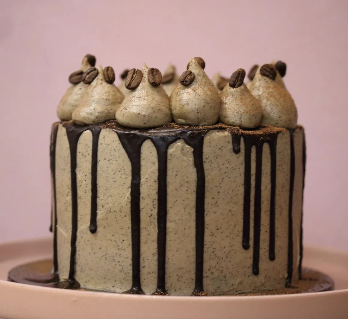 Gluten-free, dairy-free, refined sugar-free chocolate coffee cake with rich chocolate layers, a subtle coffee flavour, and a smooth coffee frosting, garnished with coffee beans