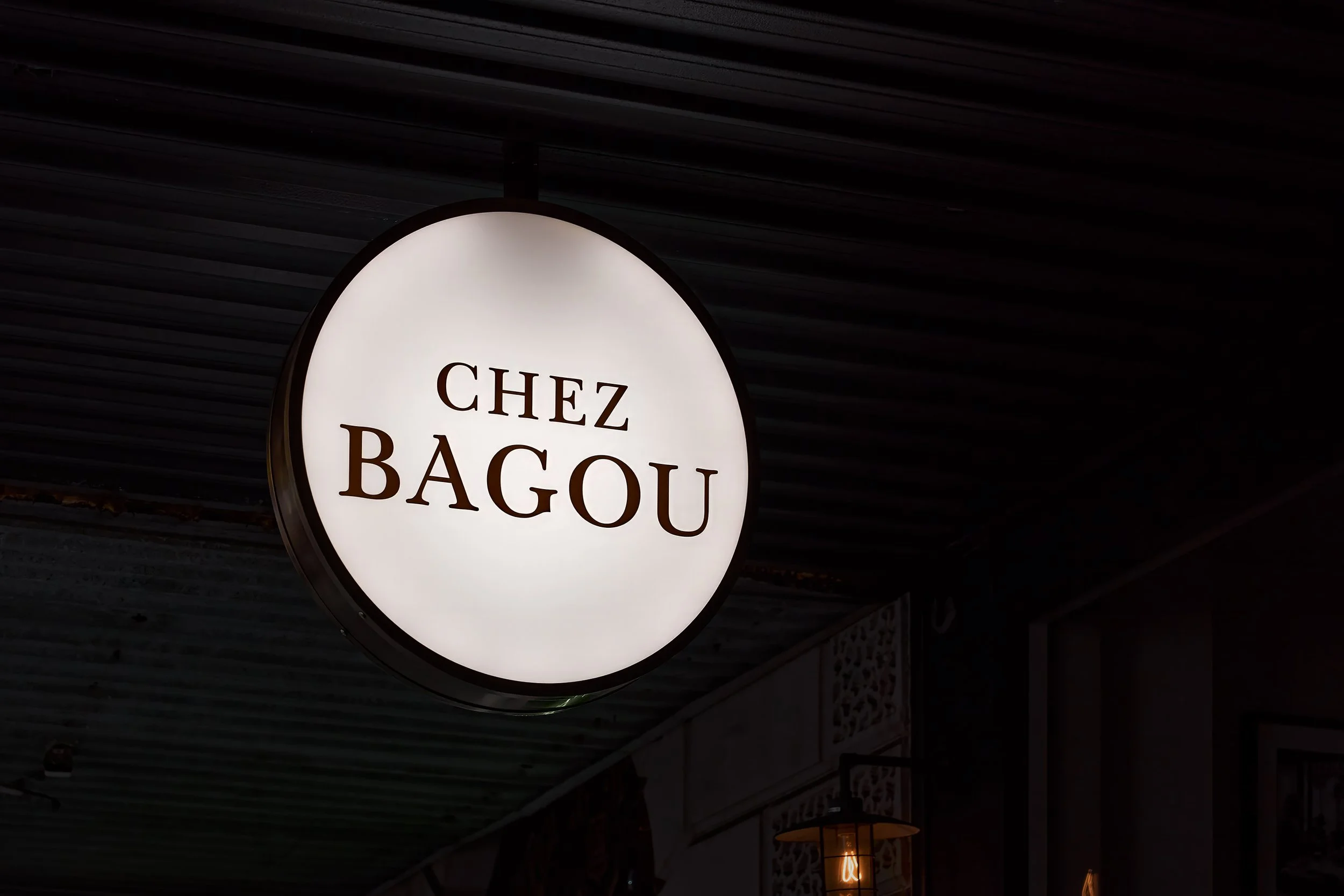 Illuminated Chez Bagou sign on the restaurant exterior, Albert Park Melbourne