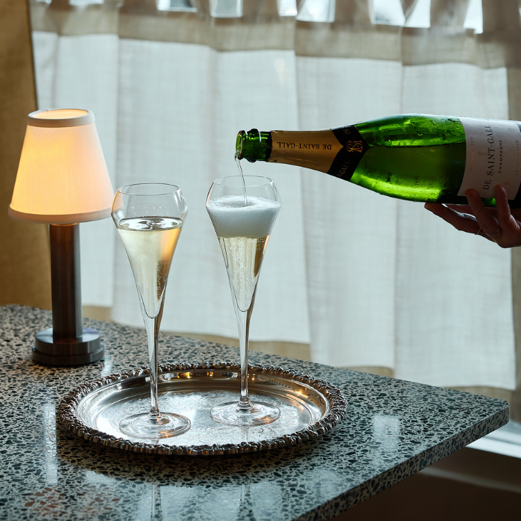 Champagne being poured into flute glasses at Chez Bagou, Albert Park Melbourne
