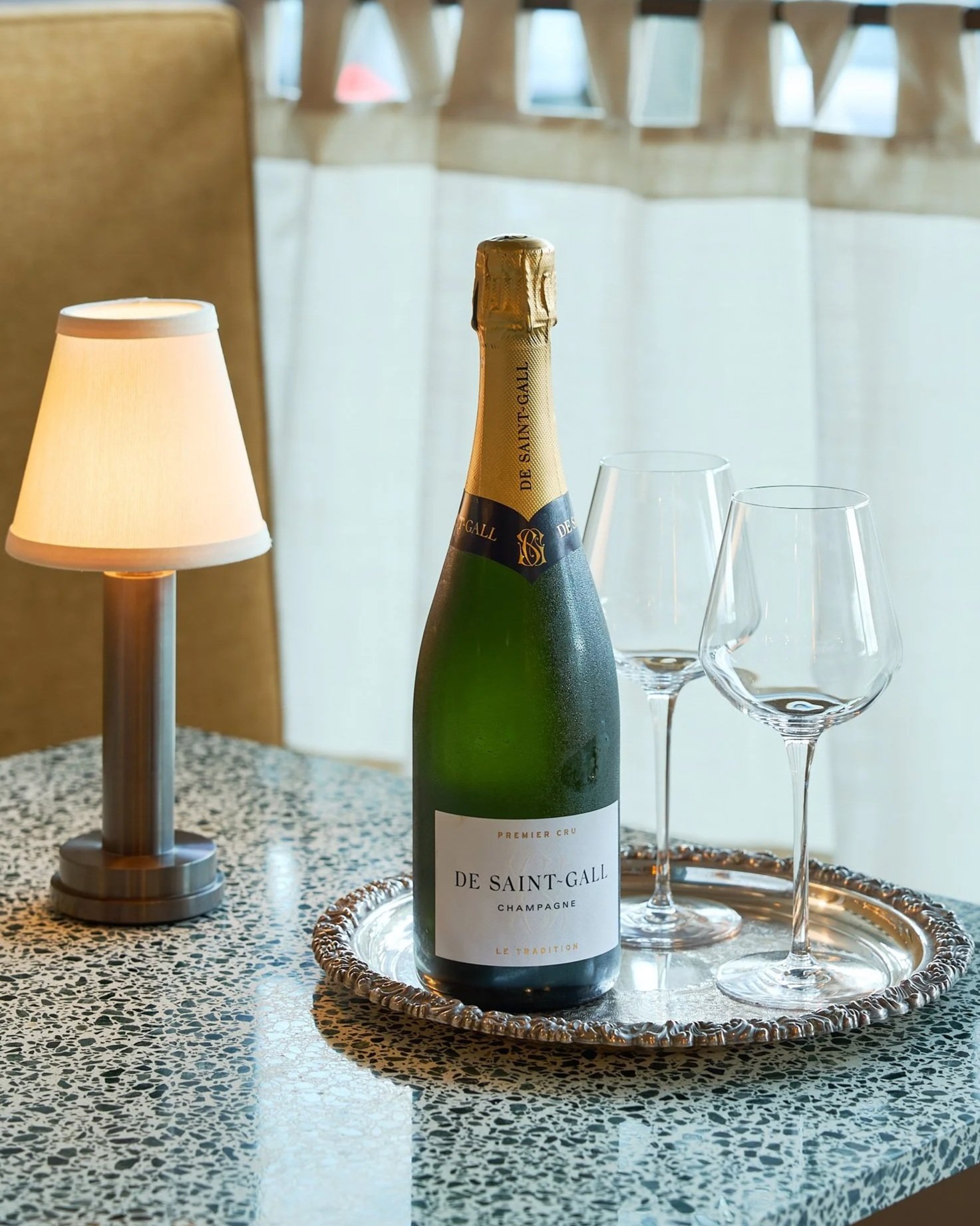 Champagne bottle and glasses on a table at Chez Bagou French Bistro
