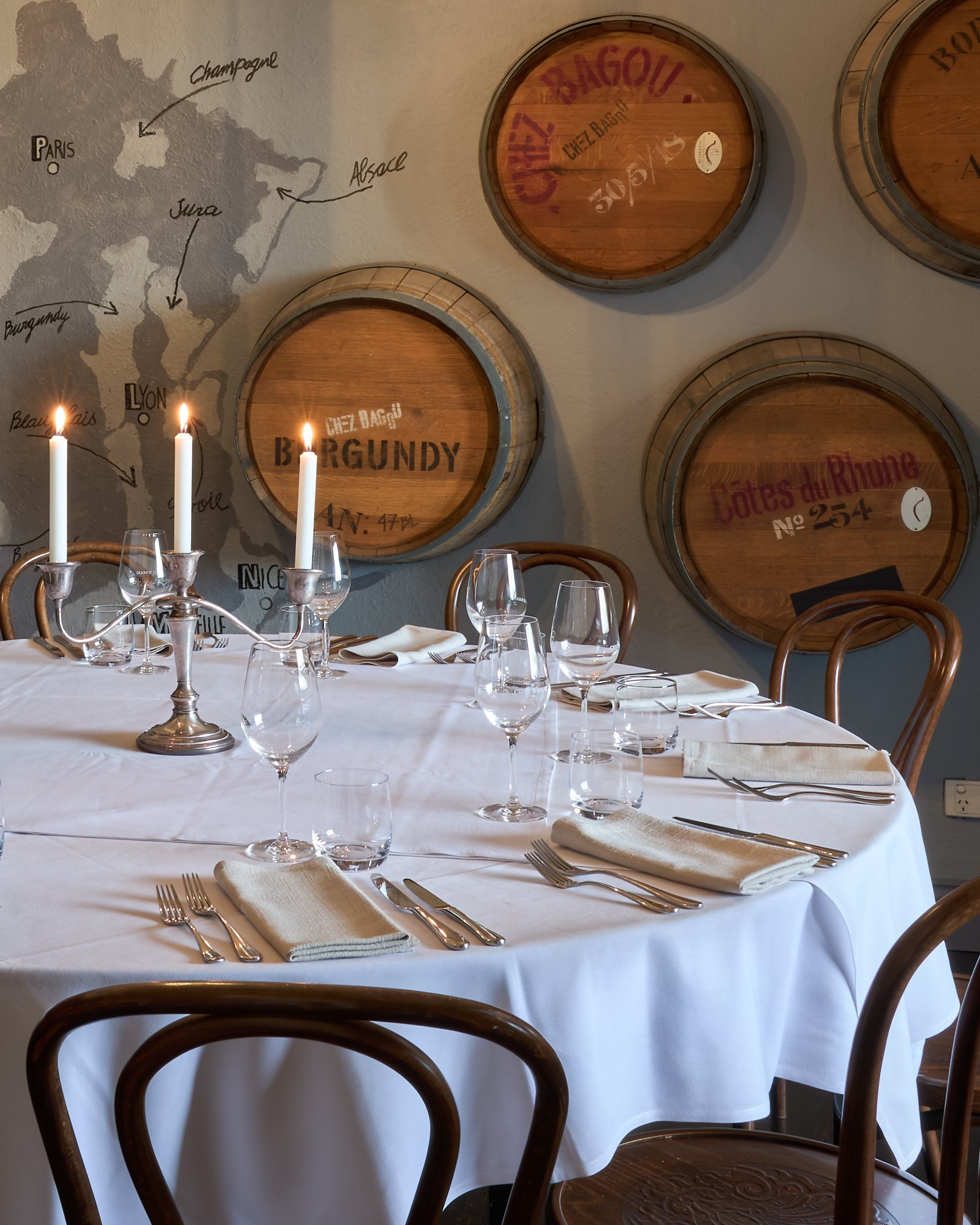 The Cellar Dining Room with wine barrel wall art at Chez Bagou, Albert Park