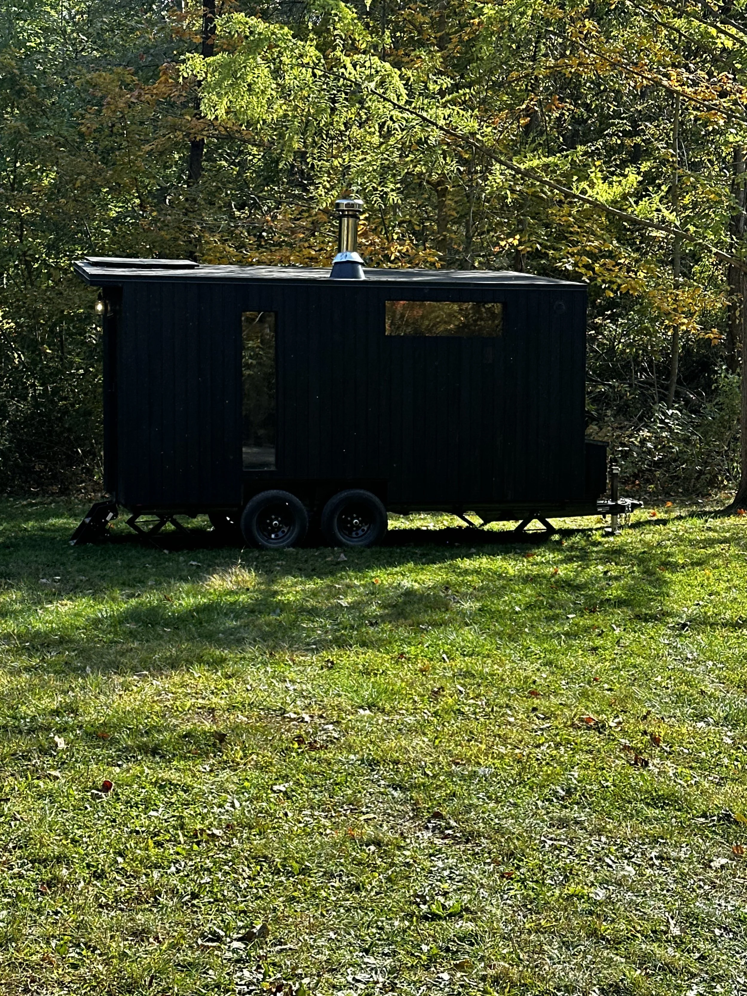 Dark Sauna Trailer in woods