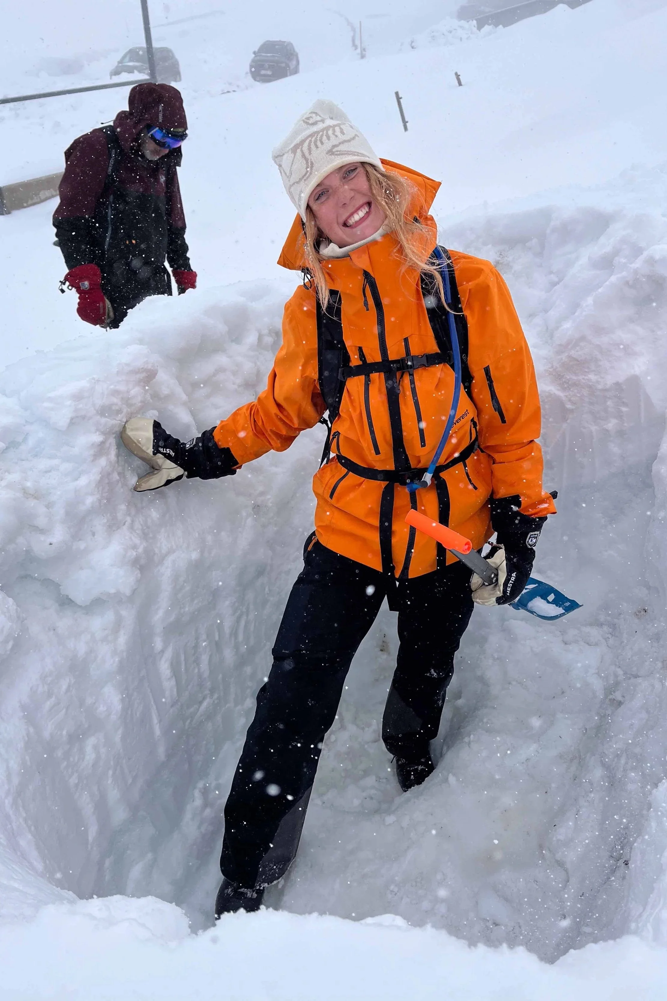 Starting the process of building an emergency snow shelter