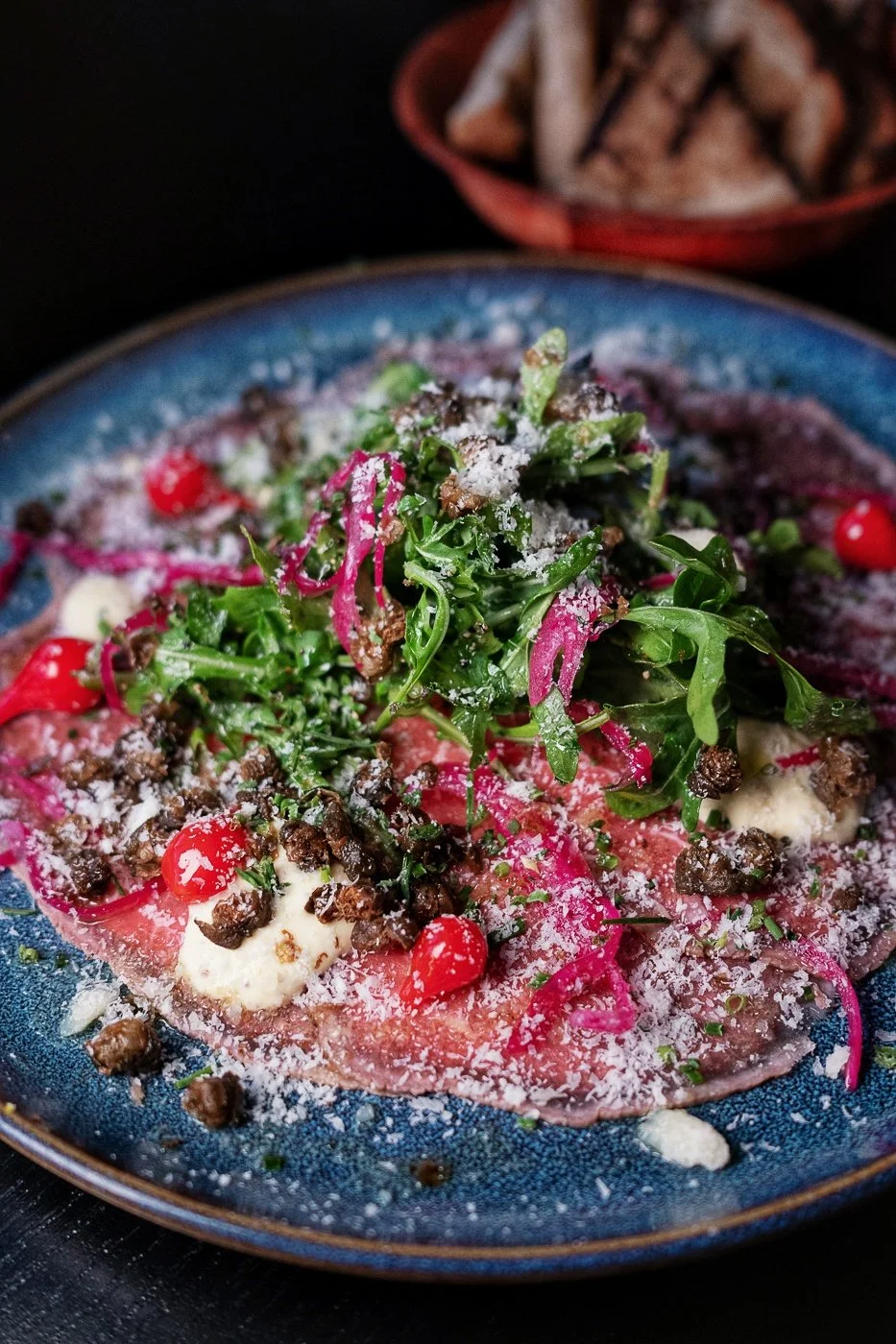 AAA Beef Carpaccio ~ Arugula, Drop Peppers, Pickled Onion, Parm