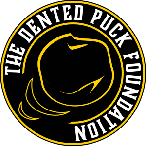The Dented Puck logo. A circular logo with The Dented Puck Foundation around the outside and a dented puck outlined in yellow on the inside