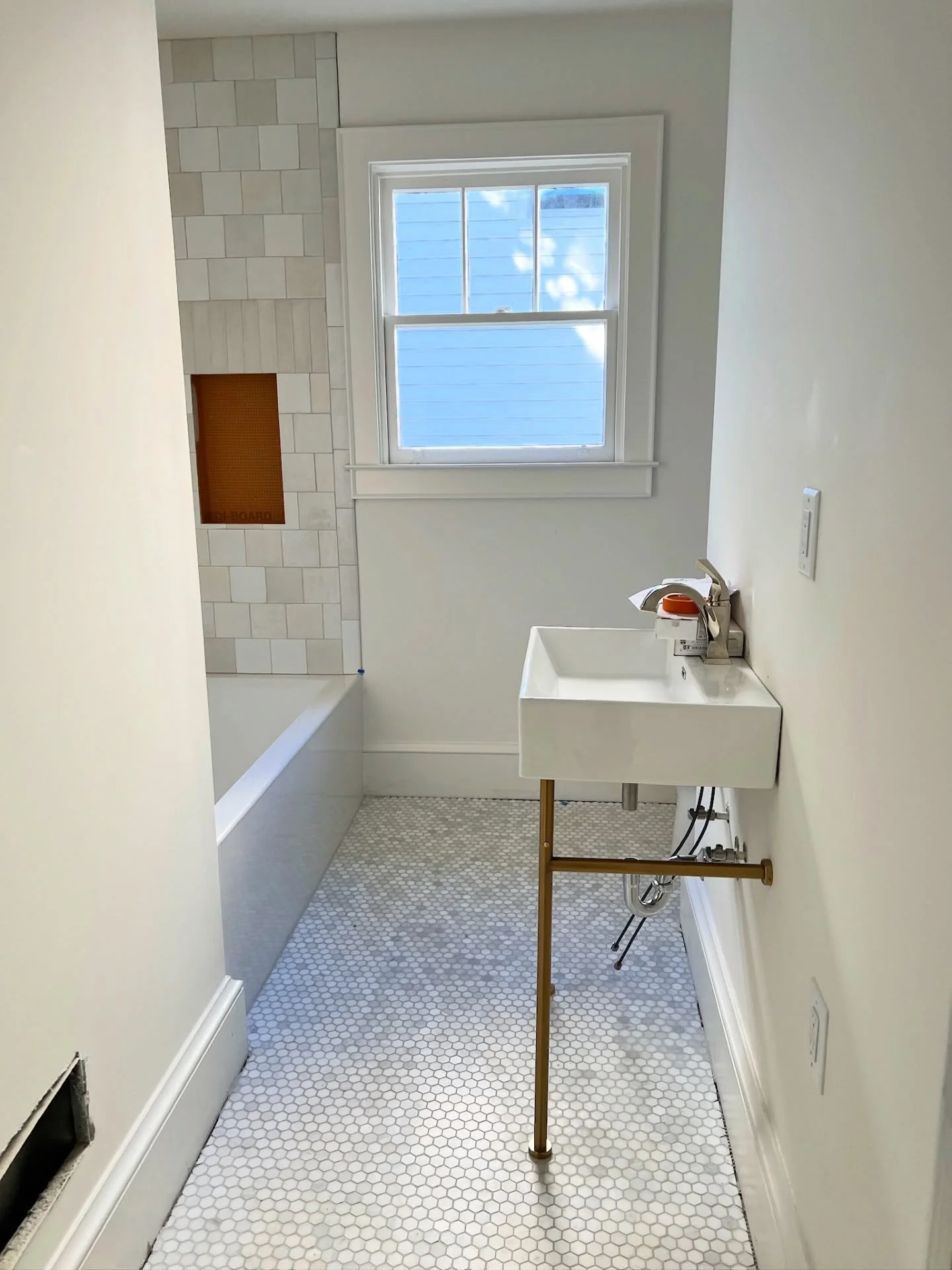 No knocking down walls required! The secret to making a small space feel high-end is all in the materials and the scale of your fixtures.

Sometimes, a renovation means working within the existing footprint. This 1940s bungalow guest bath didn&rsquo;