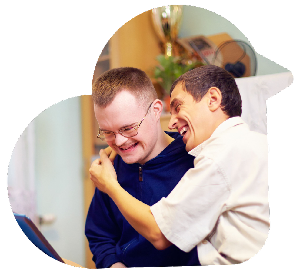 A caregiver and a client laughing together