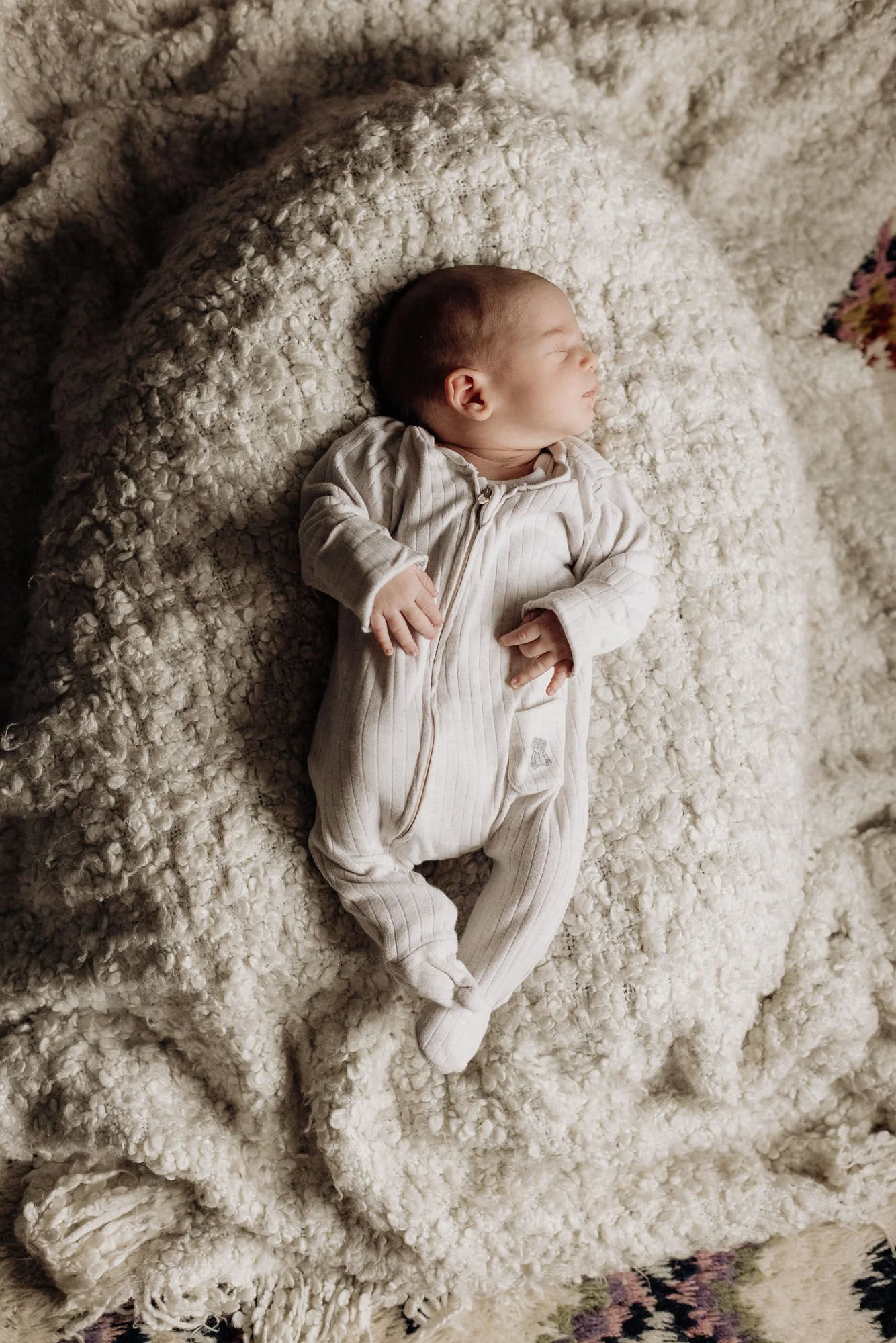 Baby sleeping on cream blanket