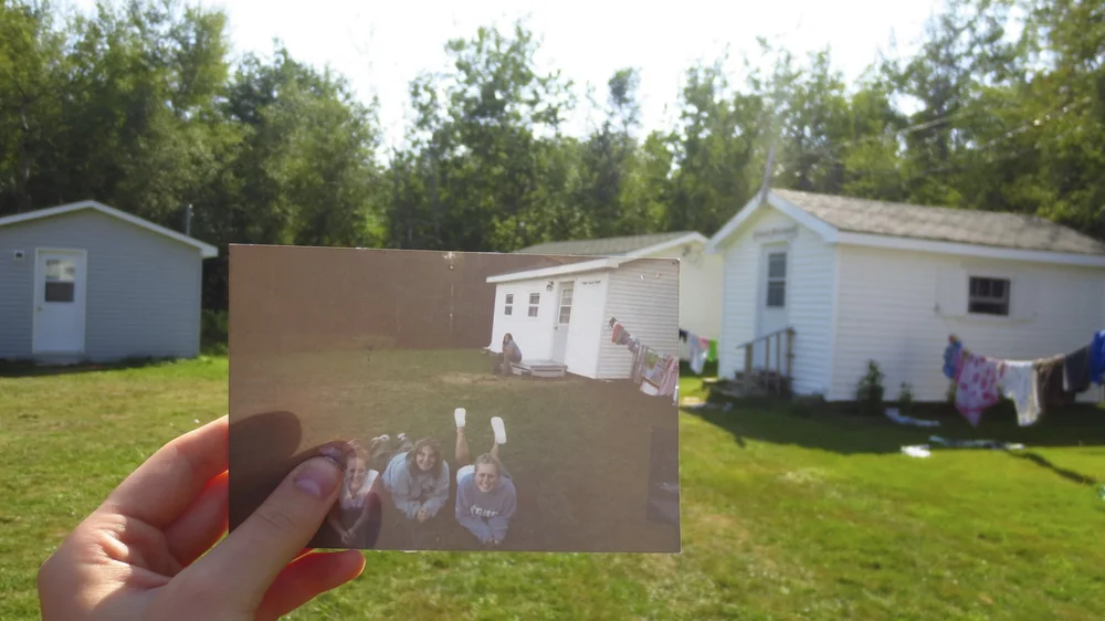 a camp photograph from 2002 held up inside the same pagweak space in 2013