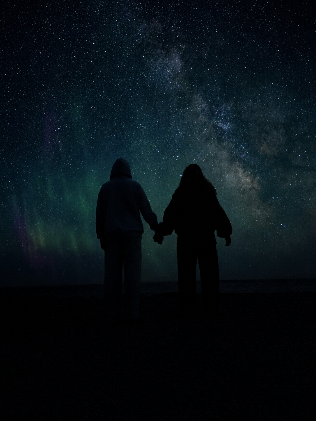 best friends holding hands beneath a galaxy-filled night sky