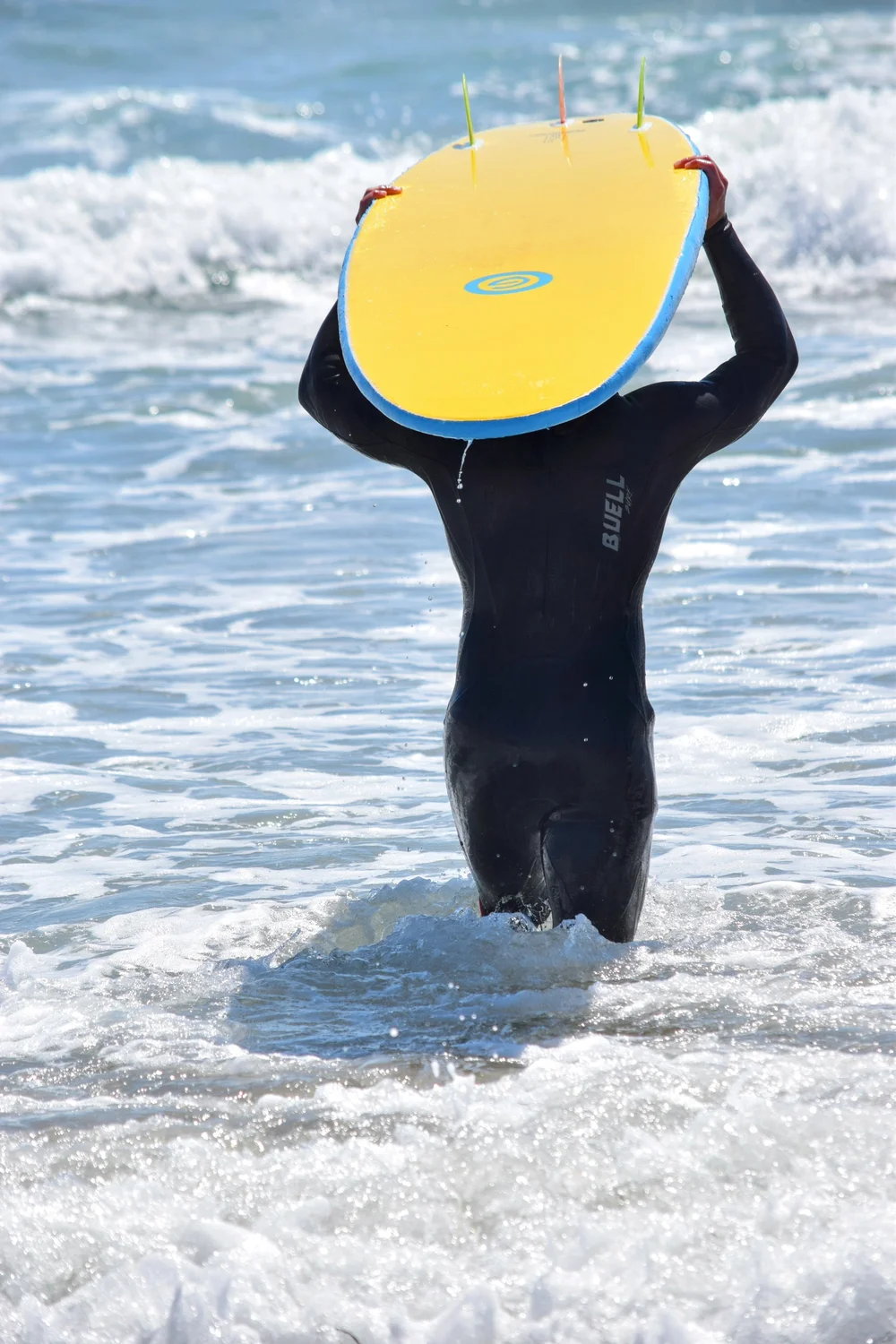 surfer carrying a board on their head