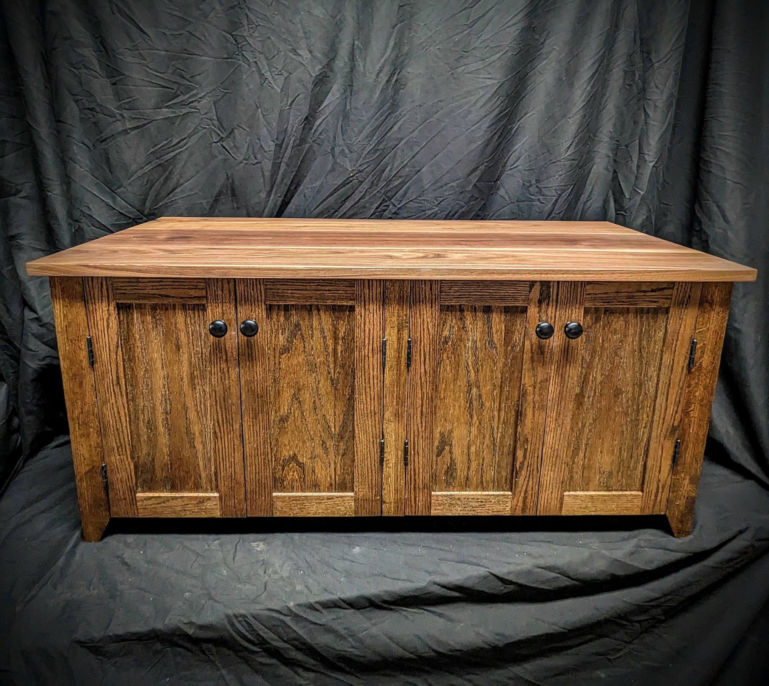 A custom cat cabinet,  Functional doors on front and sides.  Walnut top and stained plywood body and oak frames. 
