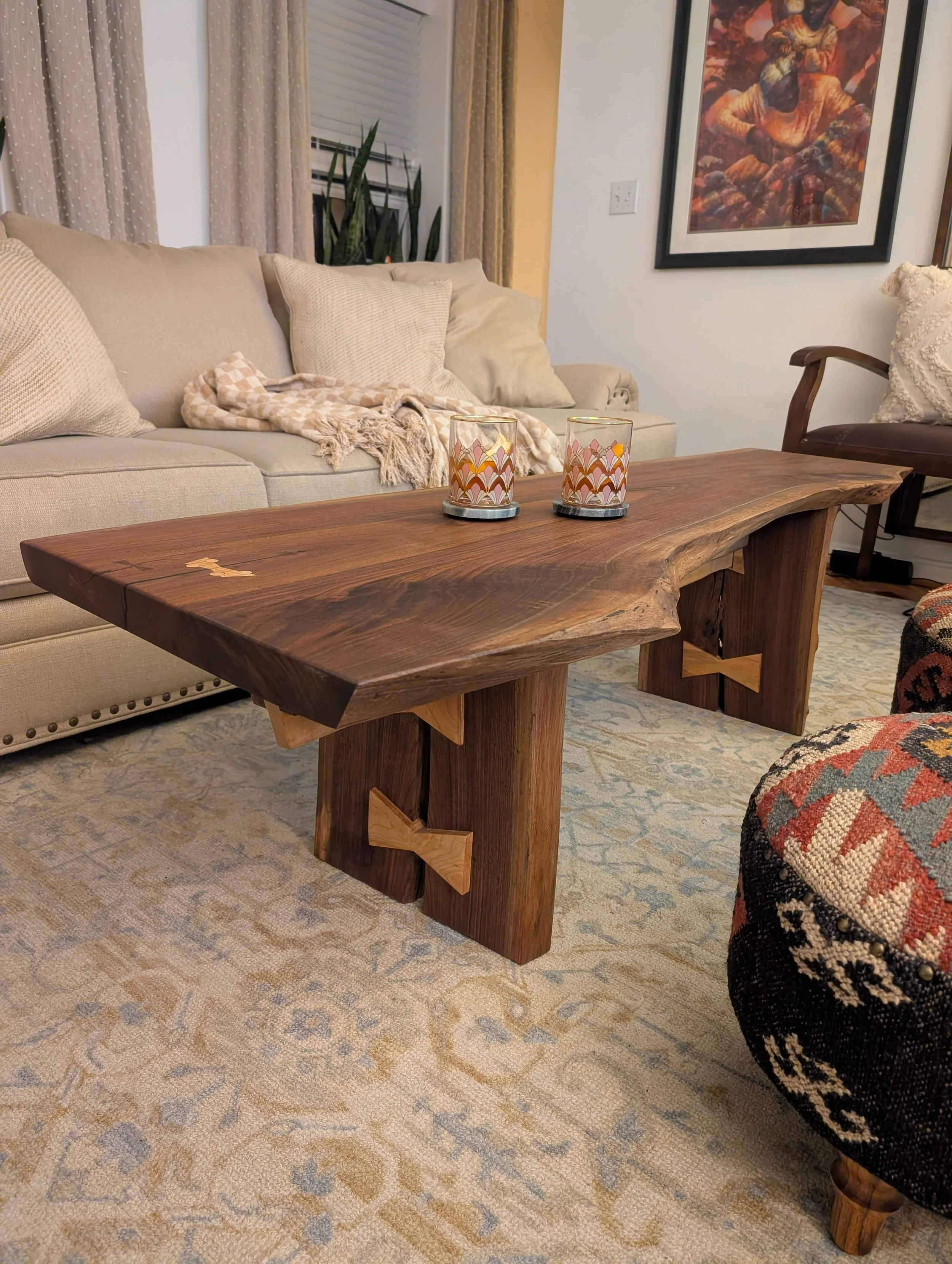 Custom live edge coffee table in walnut.  A comical amount of bowties holds beautiful piece together.  A total of 11 inlcuding the top inlays.