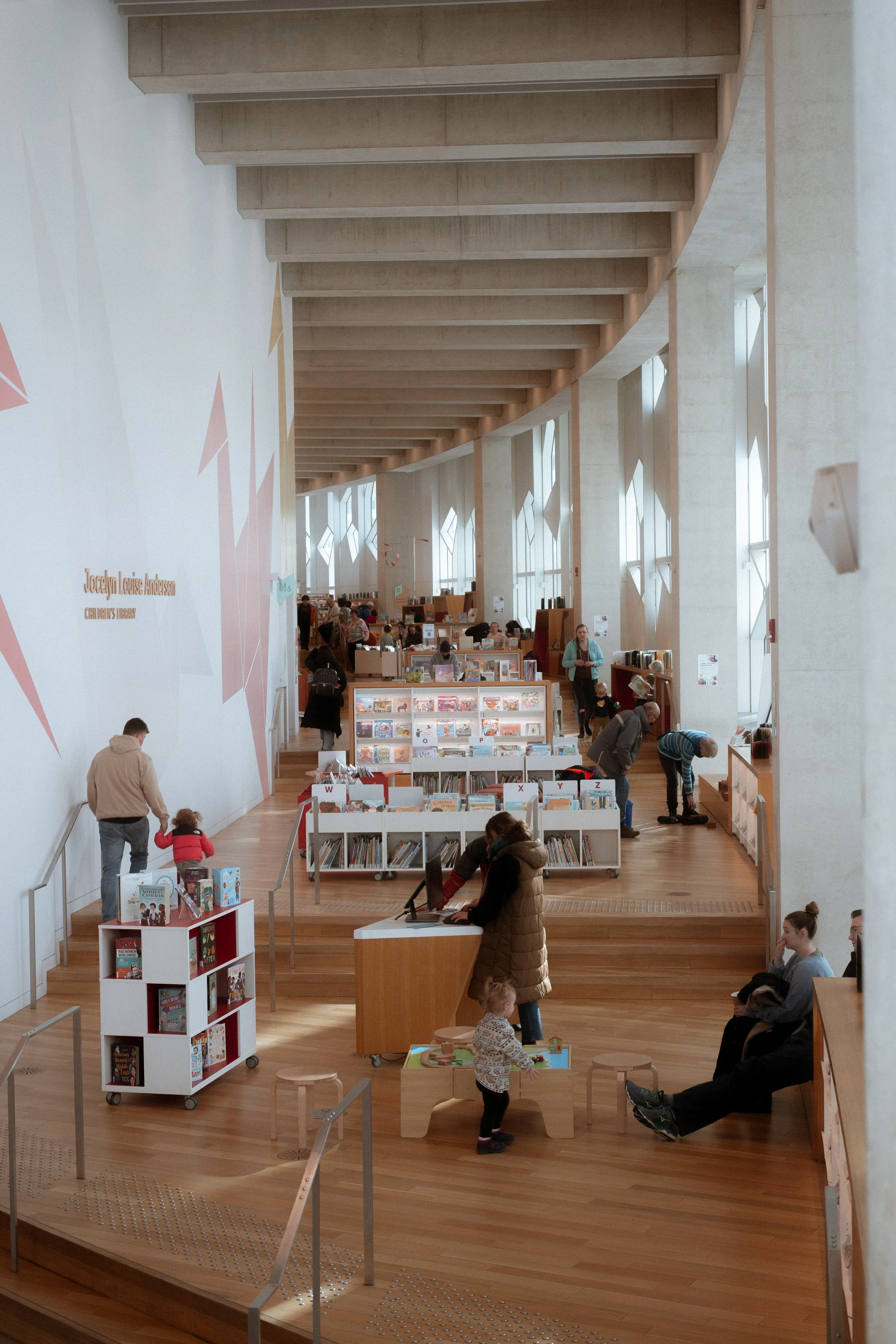 Children’s area inside Calgary Central Library showing open layout, natural light, and integrated shelving supporting active, family-focused use of the space.