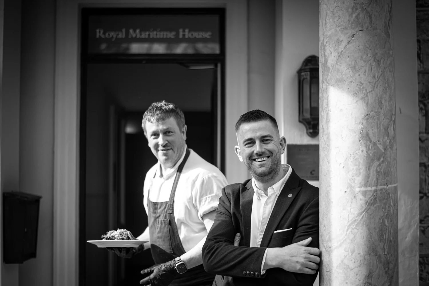 Chef Robert Thompson MBE and a member of the team at the door of Royal Maritime House