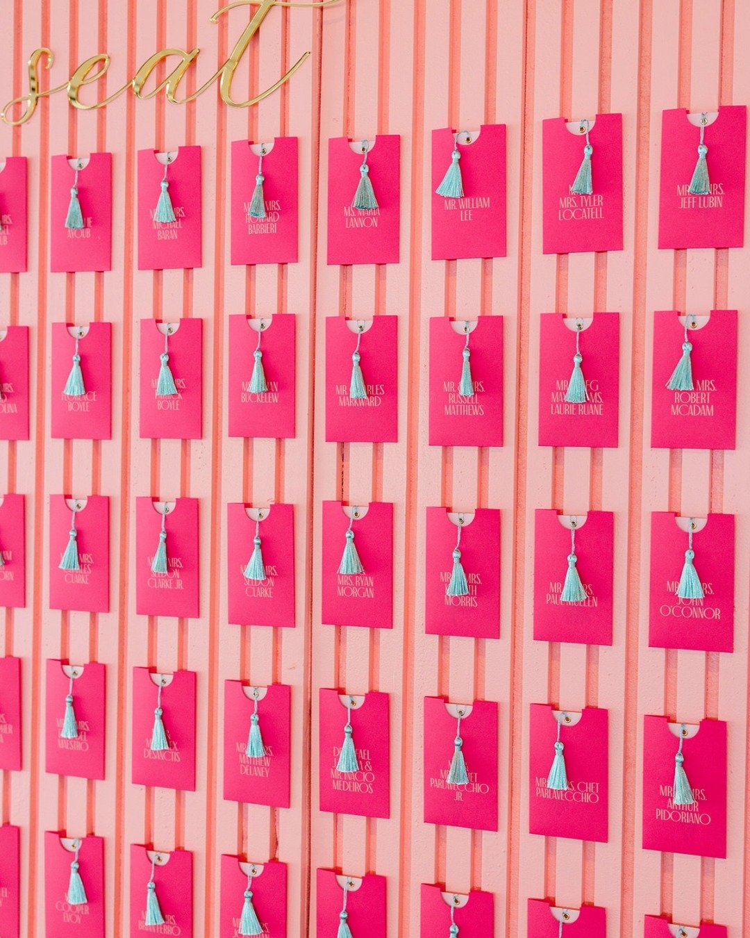 When a simple seating chart wouldn&rsquo;t cut it.⁠
⁠
This custom escort card wall brought the palette to life. Raspberry cards paired with soft turquoise tassels created a bold first impression, while the striped inset backdrop added just the right 