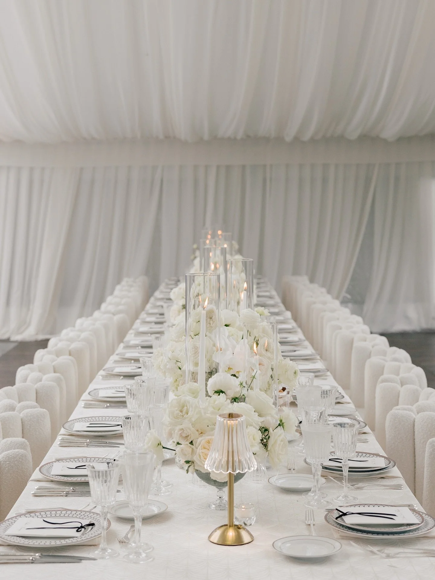 When we dreamt up this tented celebration for @hunterearle__ and @tylersaito, it was about more than building a space. It was about creating an environment. Draping softened the structure, chandeliers caught the evening light, and the waterfront view