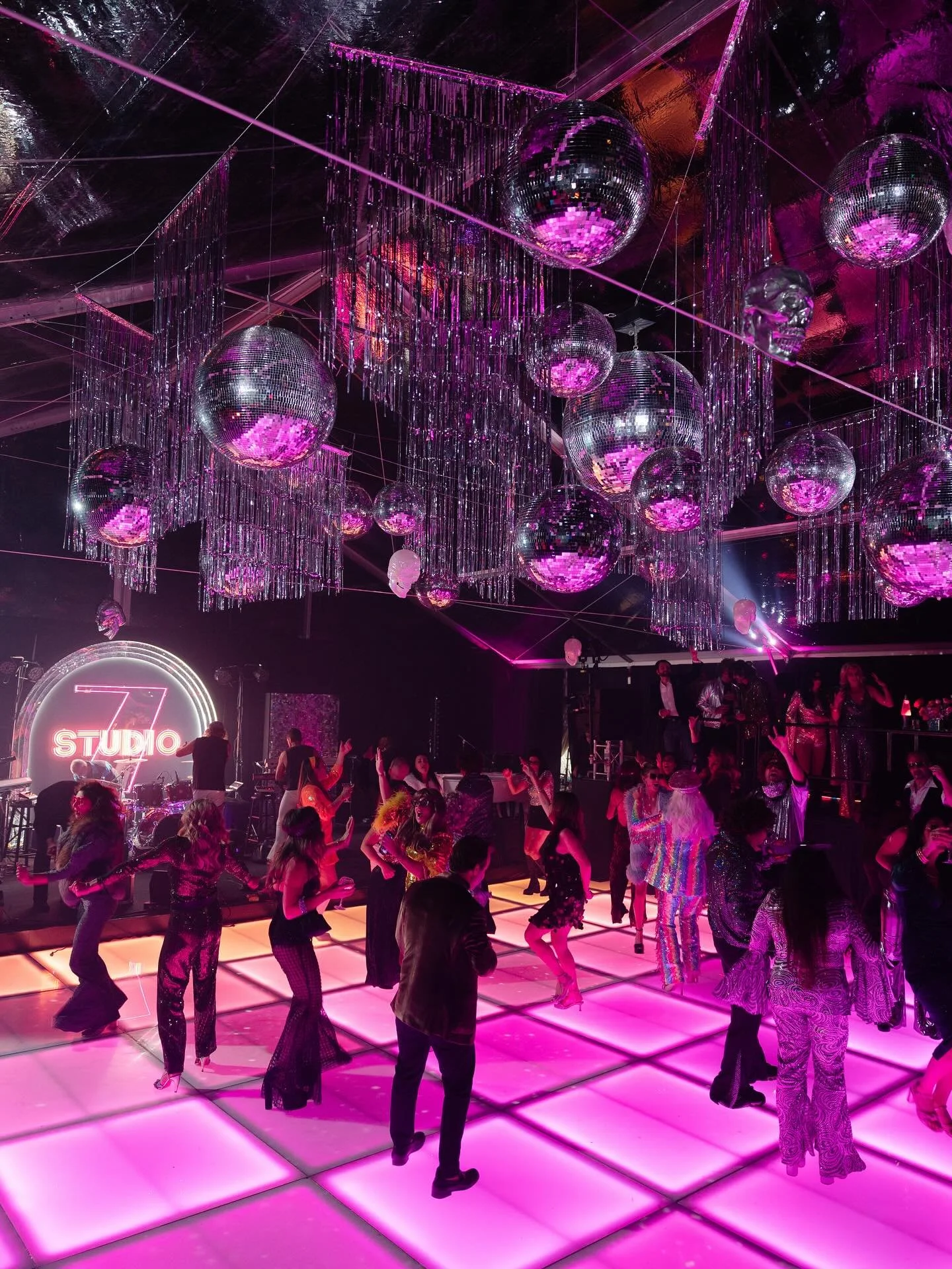 Disco isn’t dead, or is it?
Studio 54 met the supernatural for one night only. Mirrored skulls, flying disco balls, and an LED light tunnel straight out of an acid trip. Guests entered through a paparazzi-lined tent of psychedelic floral, glit