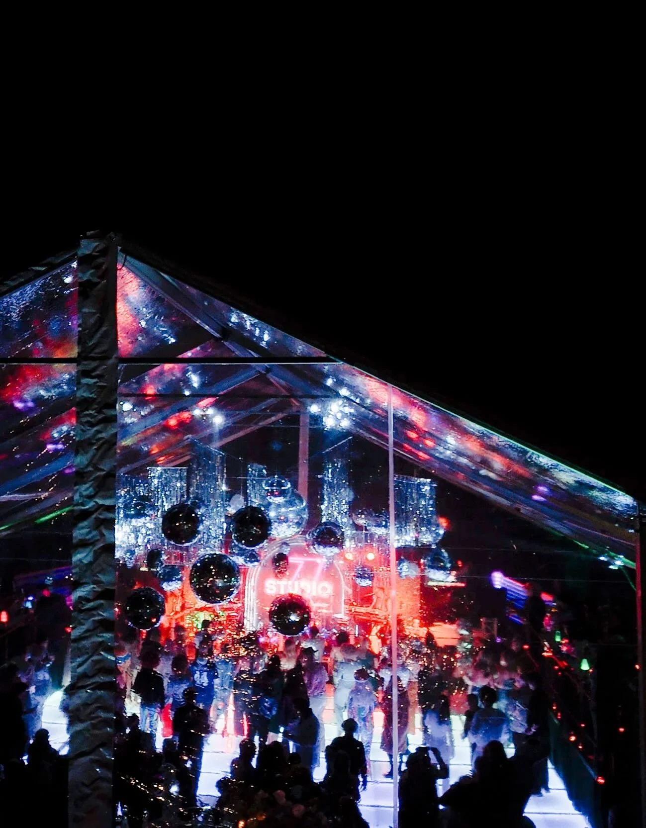 Every inch of Dead Disco was designed to hit a little harder.

A mirrorball skeleton at the bar, lava lamps flickering through chrome furniture finishes, psychedelic florals climbing the tent line, metallic fringe and disco balls suspended in motion 