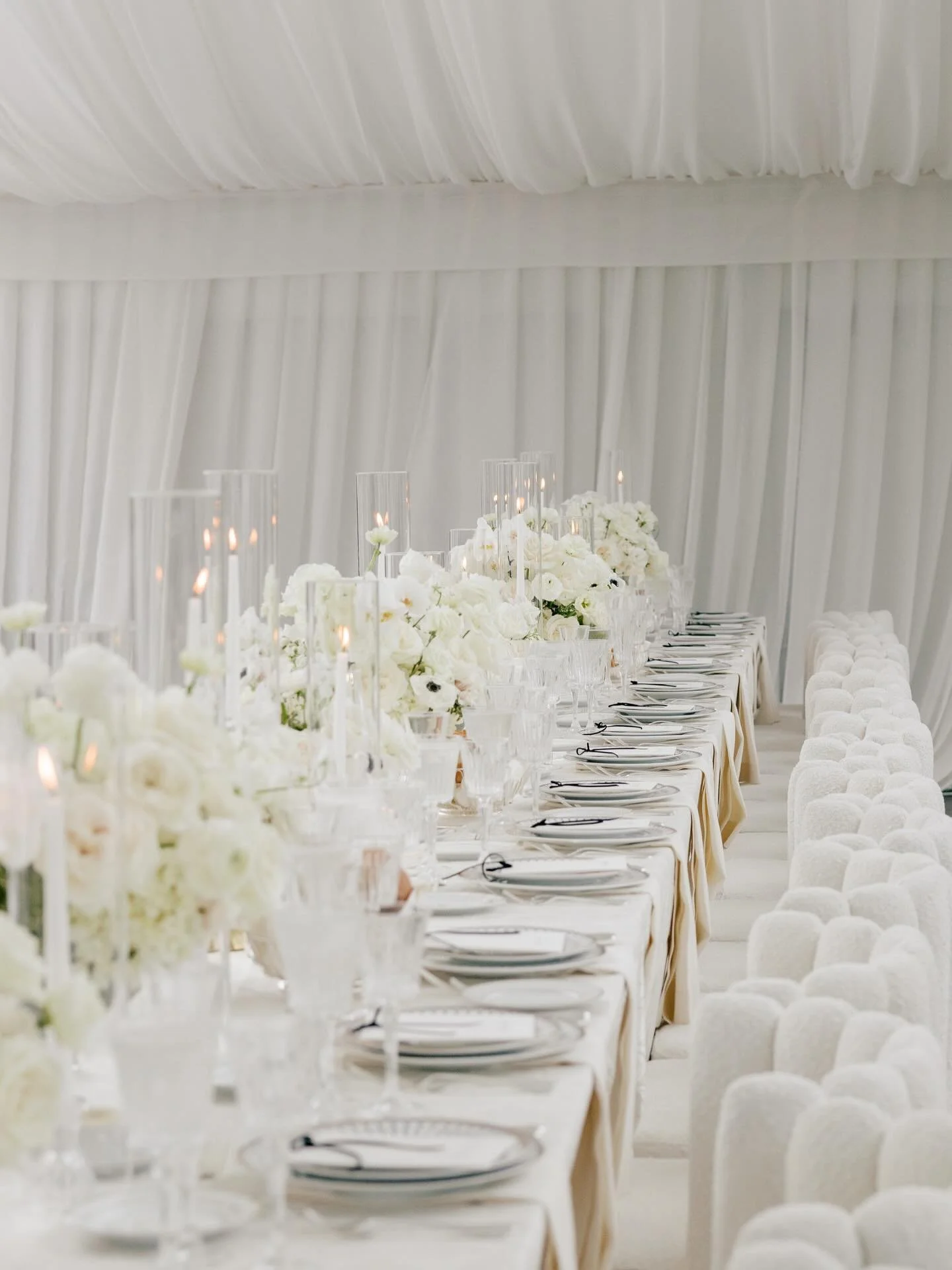 As the day moved from celebration to dinner, we wanted the reception to feel like a reveal. A wash of white, candlelight catching every surface, and florals that added dimension without ever overwhelming the room.

It was serene. It was sophisticated