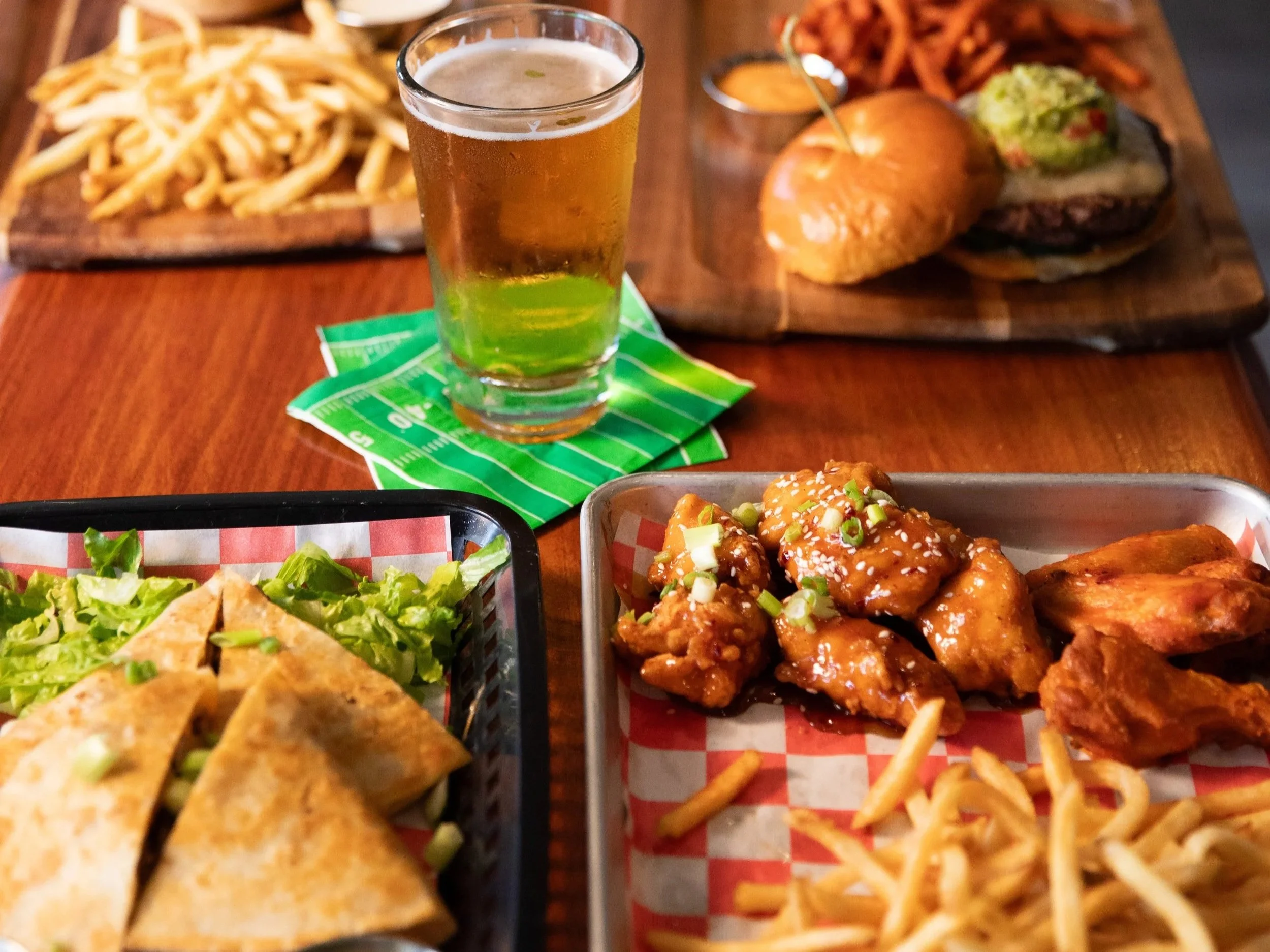 Wings, quesadillas, handhelds, fries, and beer food spread at Velocity Wings