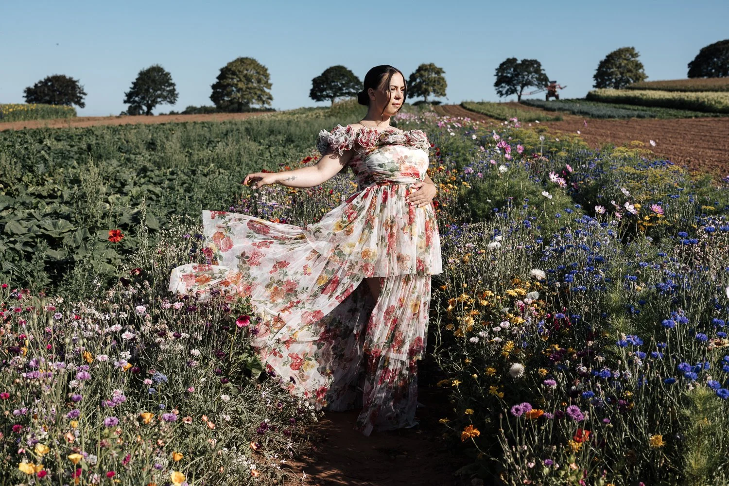 Maternity photoshoot in Plymouth Devon showing a pregnant woman in a flower field at Darts Farm