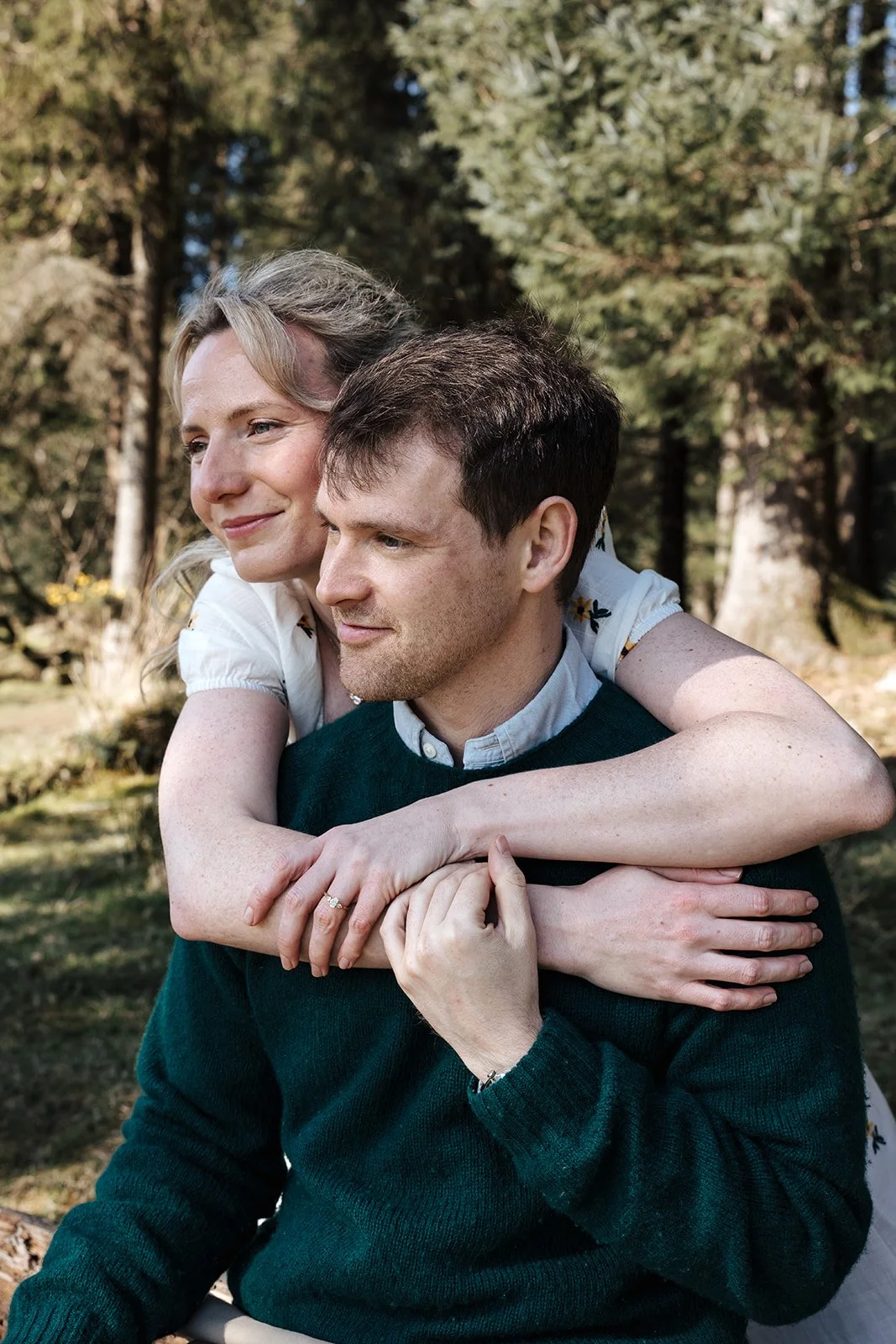 Engagement photoshoot in Dartmoor woodland with couple and their dog in a natural outdoor setting