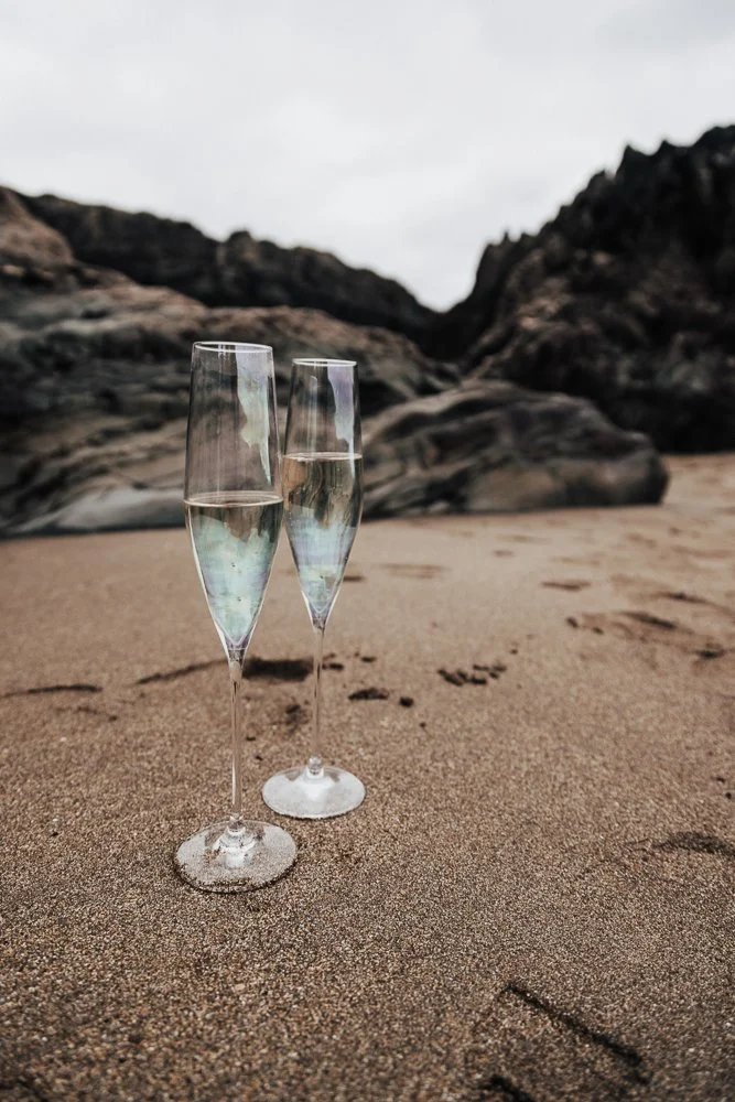 Couple celebrating engagement on Whitsand Bay beach in Cornwall
