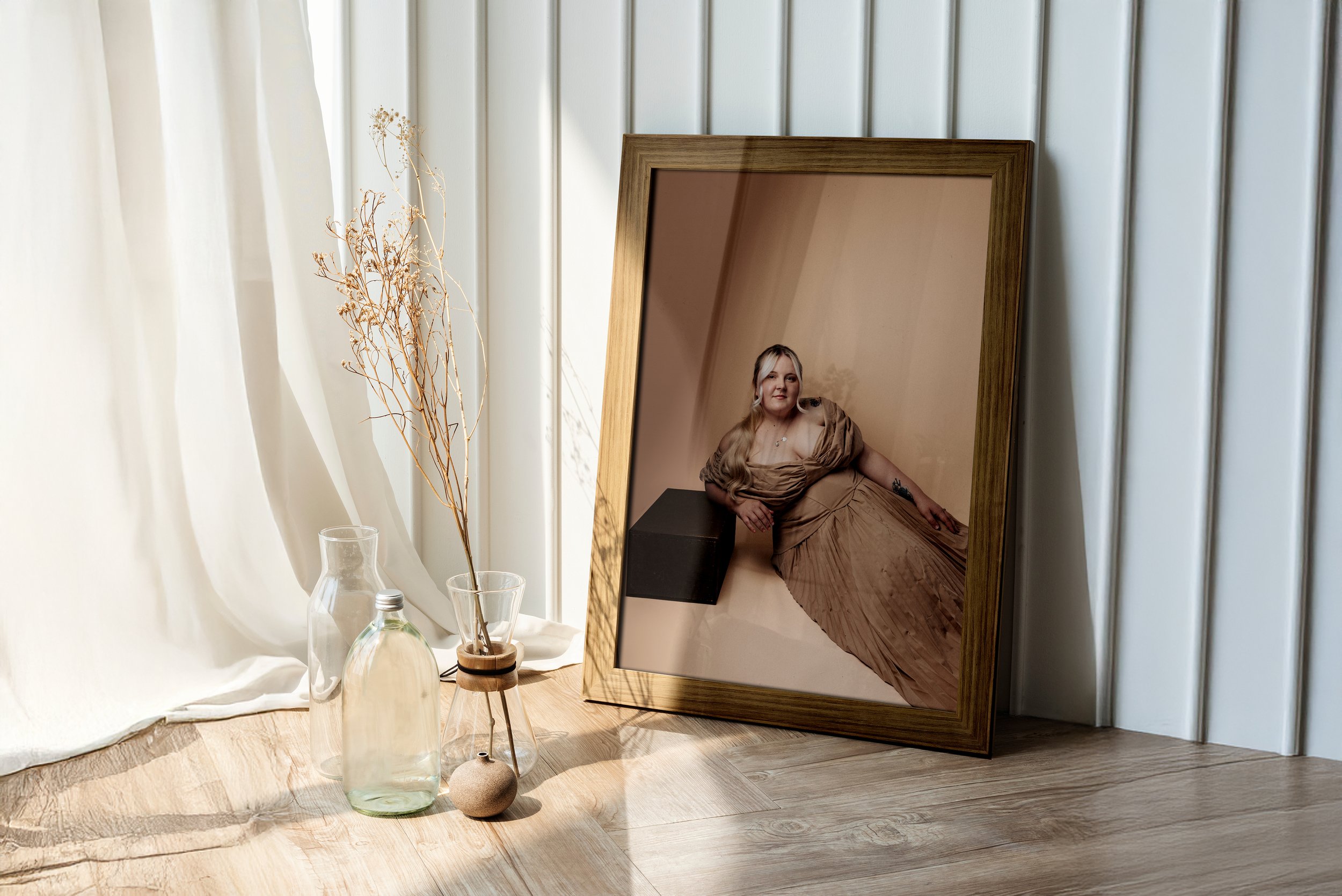 Framed wall art of a Woman looking confidently at the camera during a self-love portrait session.