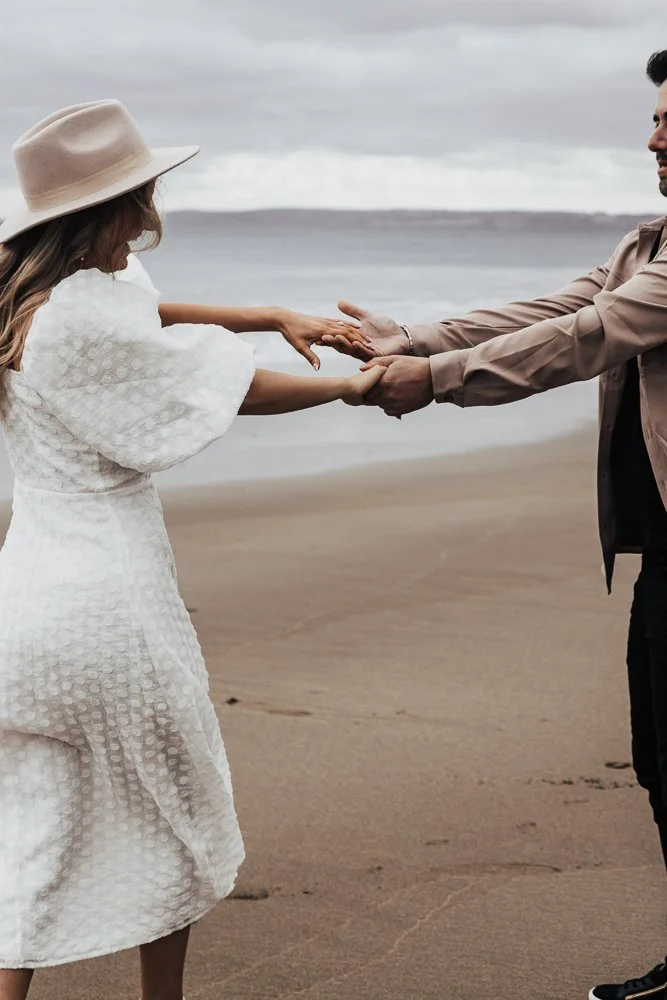 Couple celebrating engagement on Whitsand Bay beach in Cornwall